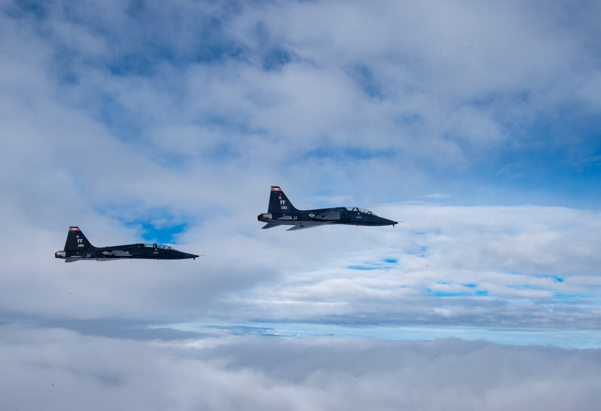U.S. Air Force T-38 Talons from the 1st Fighter Wing fly in formation of the Atlantic Ocean during training off the coast of Virginia, Oct. 30, 2019. The 1st Fighter Wing is home to the 94th Fighter Squadron, 27th Fighter Squadron and the 71st Fighter Training Squadron at Joint Base Langley-Eustis, Va. (U.S. Air Force Photo by Tech Sgt. Carlin Leslie)(Released)