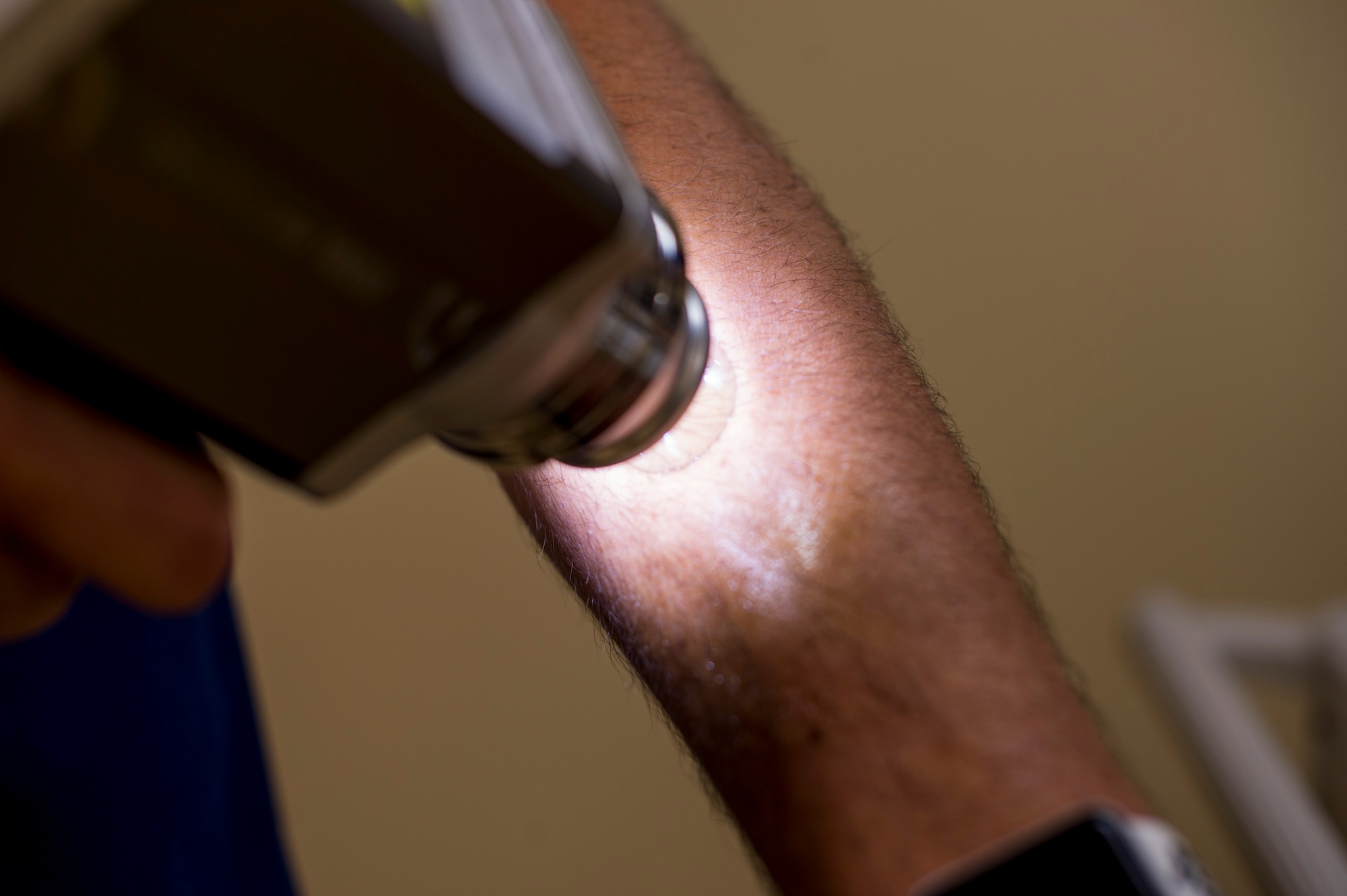 Maj. Thomas Beachkofsky, 6th Healthcare Operations Squadron dermatologist, demonstrates how a body scanner microscope works at MacDill Air Force Base, Fla., Oct. 30, 2019.