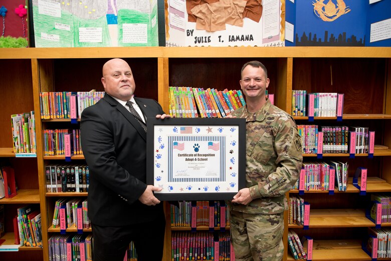 U.S. Army Corps of Engineers (USACE) Vicksburg District Commander Col. Robert A. Hilliard and Beechwood Elementary School principal David Adams hold an adoption certificate Nov. 4 at Beechwood Elementary School in Vicksburg, Mississippi.