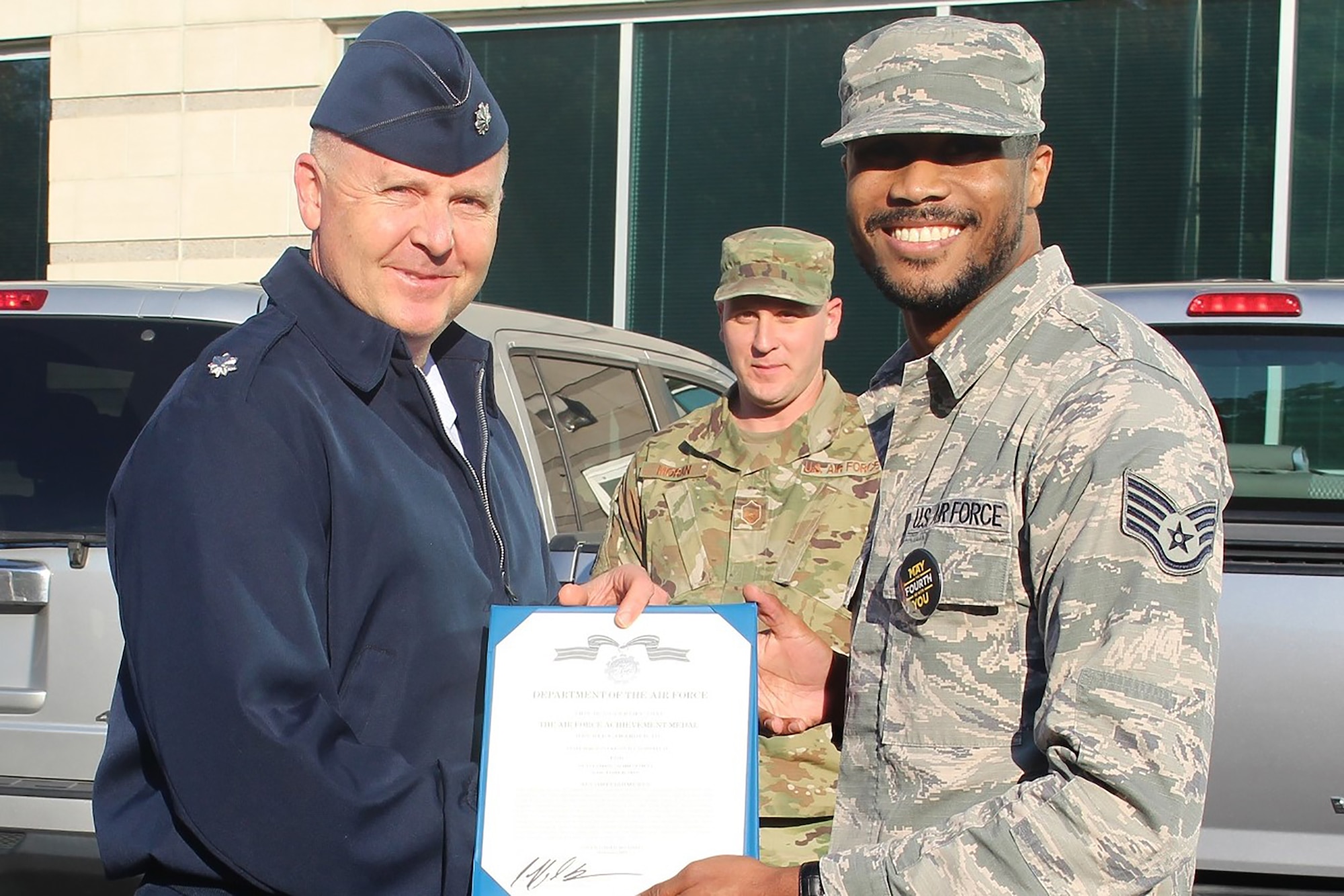 655th Intelligence, Surveillance, and Reconnaissance Wing, 16th Intelligence Squadron Commander Lt. Col. Jeffrey Derr presents the Air Force Achievement Medal to Staff Sgt. Caldwell (first name withheld) November 2, 2019.  Caldwell earned the medal for heroic actions on October 6, when he saved a young girl’s life by preventing her from jumping off an interstate on-ramp.  First responders claimed the 60-foot drop would have been fatal. (Courtesy photo)