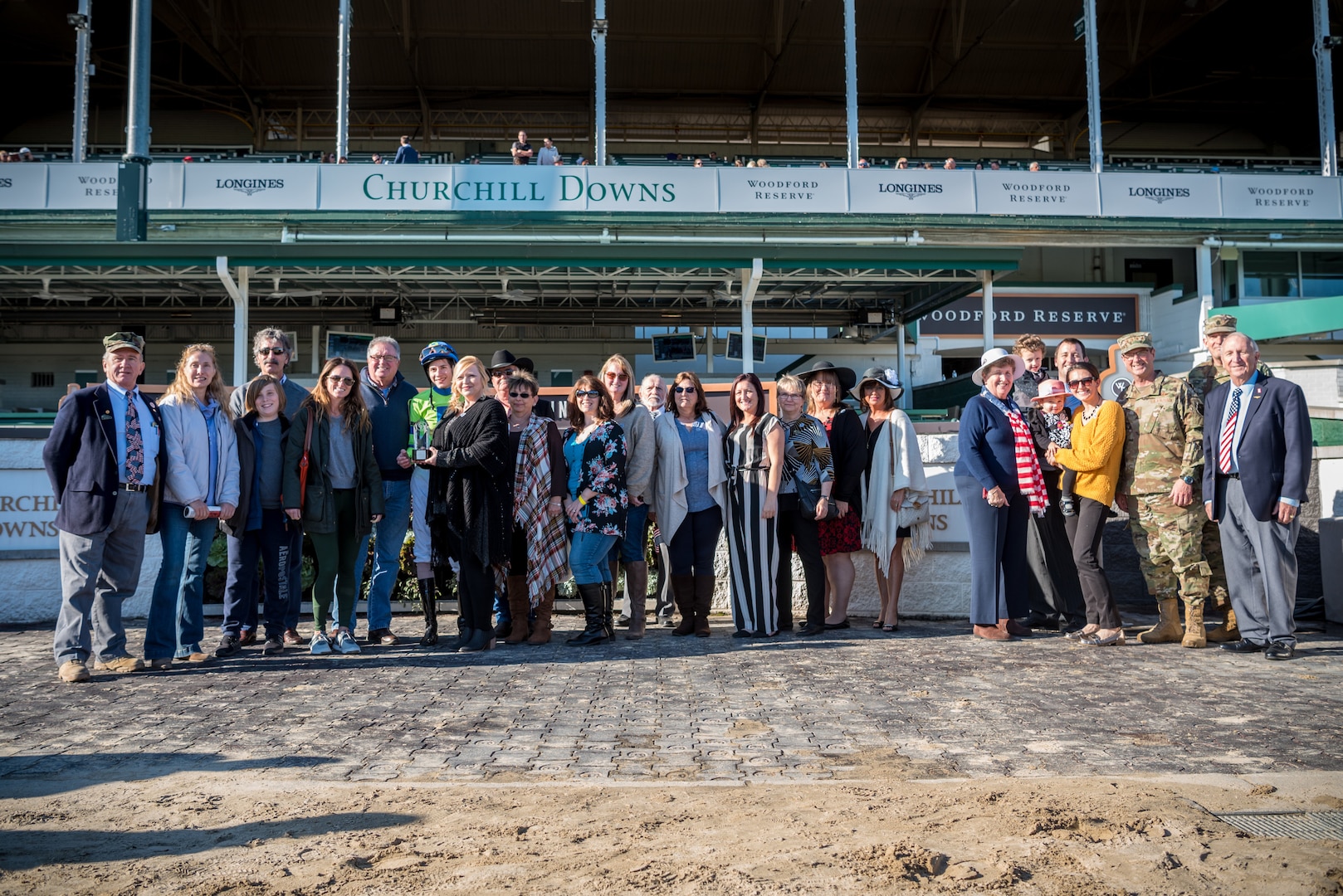 Gold Star family members are joined by Air Force Gen. Joseph Lengyel, chief of the National Guard Bureau, in the winner's circle to present the trophy for a race named in honor of Gold Star Families at the 10th annual Survivors Day at the Races at Churchill Downs in Louisville, Ky., Nov. 3, 2019. The event welcomed nearly 1,000 family members of fallen service members for a day of fellowship and healing.