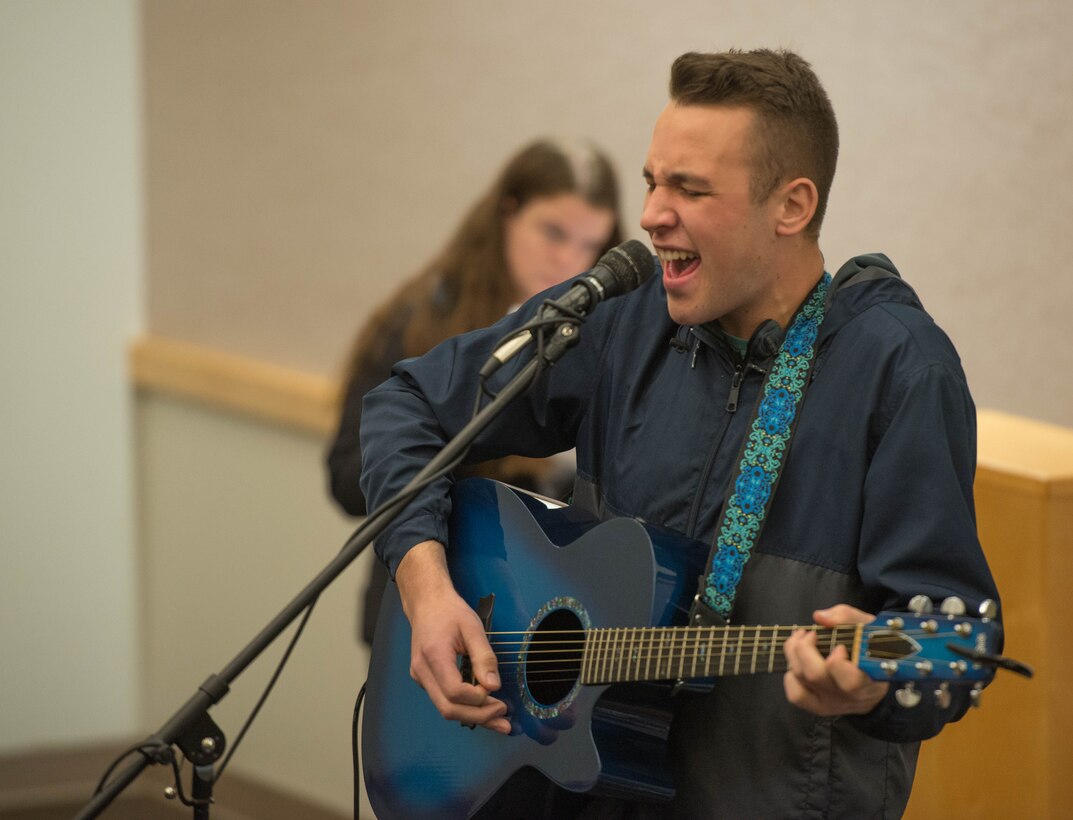 Senior Airman Jakob Reinke, 509th Aircraft Maintenance Squadron Crew Chief, hits a high note during the inagural Kick Back Day on November 1, 2019, at Whiteman Air Force Base, Missouri. The jam session event at the Whiteman Kick Back Day allowed Airman with musical talent to express themselves with either their personal or borrowed instruments. (U.S. Air Force Photo by Airman 1st Class Thomas Johns)