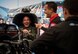 Brig. Gen. Robert Novotny, 57th Wing Commander, laughs with Bob Tasca III, National Hot Rod Association (NHRA) funny car racer, as he tries to fit into Tasca’s funny car seat during the NHRA Nationals at the Las Vegas Motor Speedway, Nevada, Nov. 1, 2019. Tasca and his team demonstrated his funny car’s capabilities to Novotny. (U.S. Air Force photo by Airman 1st Class Bailee A. Darbasie)