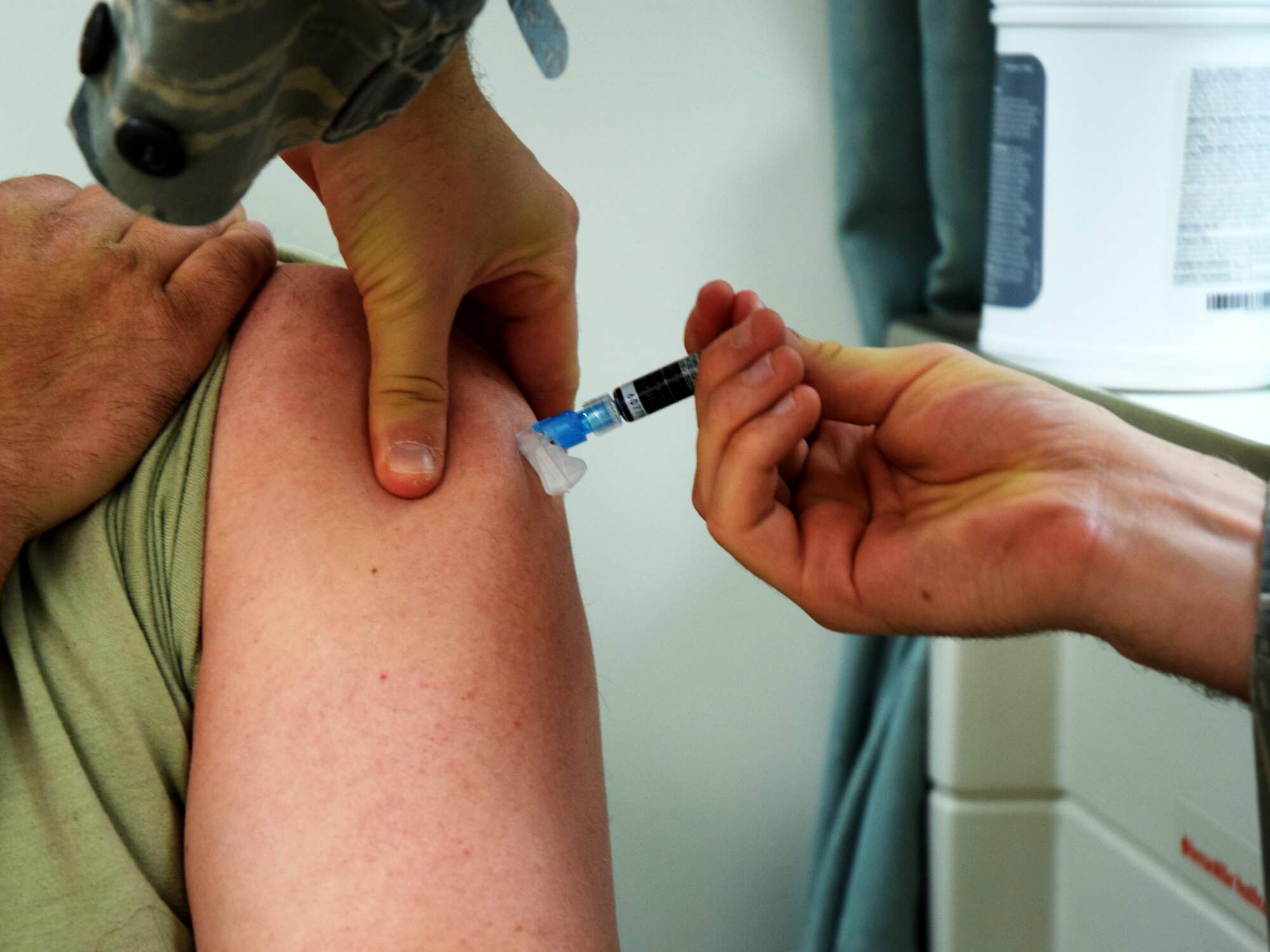 An Airman receives an influenza vaccine on Peterson Air Force Base, Colorado, Oct. 29, 2019. Vaccination helps prevent the spread on influenza and other infectious diseases, eliminating one more obstacle to Airman wellness and to the mission. (U.S. Air Force photo by Griffin Swartzell)