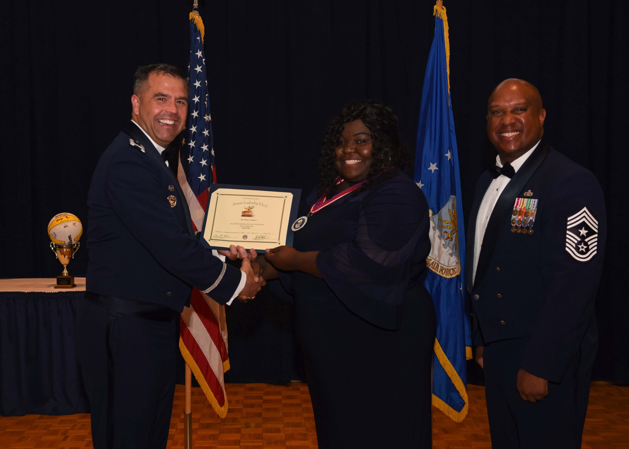 Monica Ashmore, 30th Force Support Squadron lodging assistant manager, receives a certificate during her Airman Leadership School graduation ceremony Oct. 10, 2019, at Vandenberg Air Force Base, Calif. Ashmore is the first civilian to graduate from the Vandenberg Airman Leadership School. The school is a five week course designed to develop Airmen and their civilian counterparts into effective frontline supervisors through group discussion, unit-cohesion activities, physical training and other leadership development curriculum. (U.S. Air Force photo by Airman 1st Class Aubree Milks)