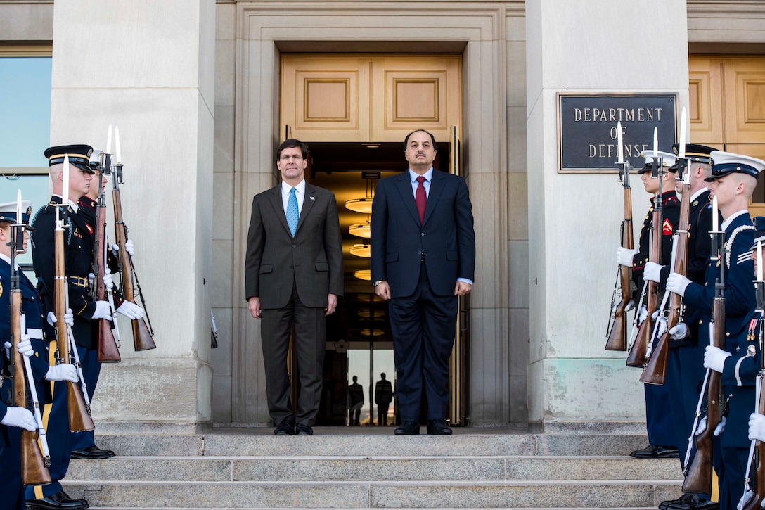 Defense Secretary Dr. Mark T. Esper and another man stand at the top of steps; service members stand on either side.