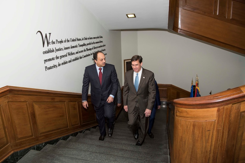 Defense Secretary Dr. Mark T. Esper walks up stairs with another man.