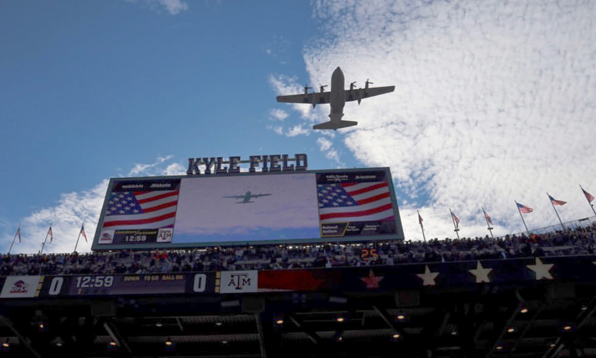 The C-130H Hercules flies over Kyle Field.