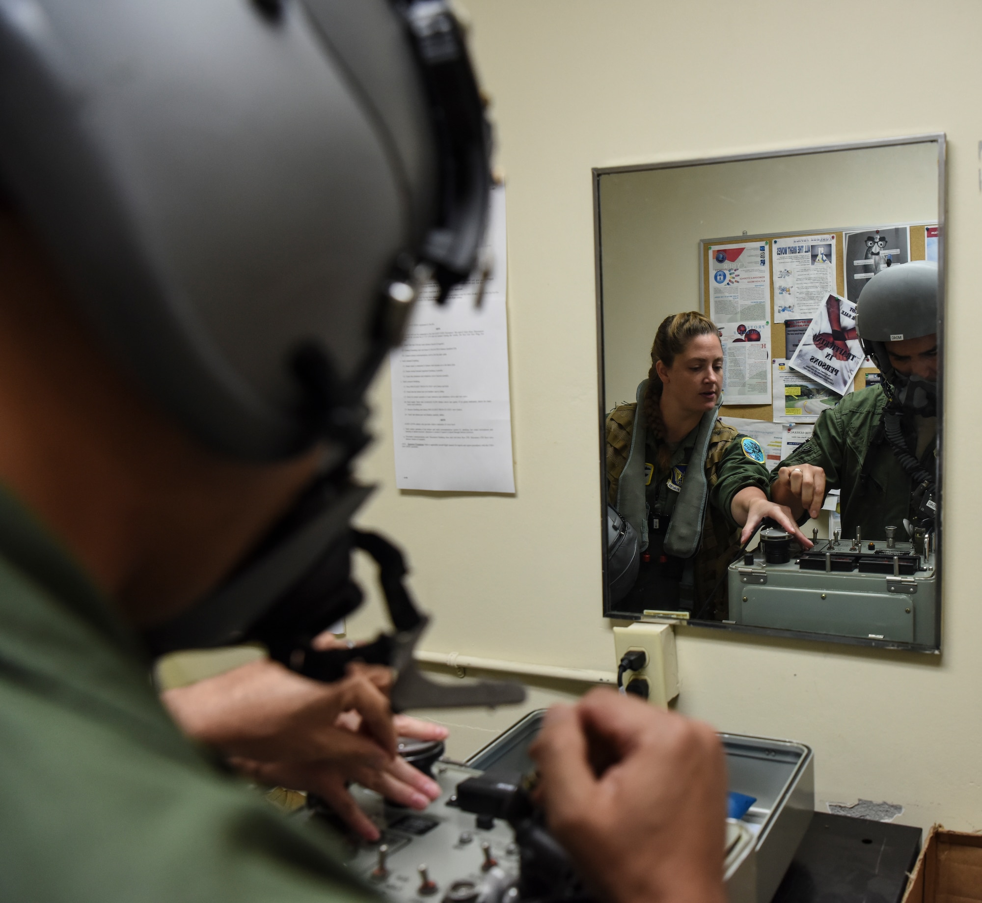 Capt. Rachel Long (left), 69th Expeditionary Bomb Squadron radar navigation officer, and Capt. Jon Guile, 69th EBS B-52 Stratofortress aircraft commander, check their helmets on an Oxygen Mask Test Unit on Andersen Air Force, Guam, Oct. 22, 2019. The 69th EBS aircrew members support the Indo-Pacific region by fulfilling the Continuous Bomber Presence mission housed on Andersen. The CBP provides rapid global strike capabilities, assurance to our allies in deterrence to possible adversaries, and maintains security and stability in the Indo-Pacific region. (U.S. Air Force photo by Airman 1st Class Michael S. Murphy)