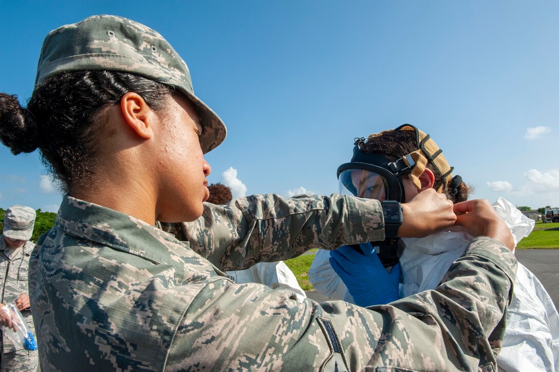U.S. Air Force Airman Georgia Knight, 18th Aerospace Medicine Squadron bioenvironmental engineering technician, assists an Airman into a level-A suit during a fuel spill exercise at Kadena Air Base, Japan, Oct. 25, 2019. The level-A suit is the highest level protection against vapors, gases, mists and particles, which consists of a fully encapsulating chemical entry suit with a self-contained breathing apparatus. It’s protects Airmen from hazardous material and harmful environments. (U.S. Air Force photo by Naoto Anazawa)