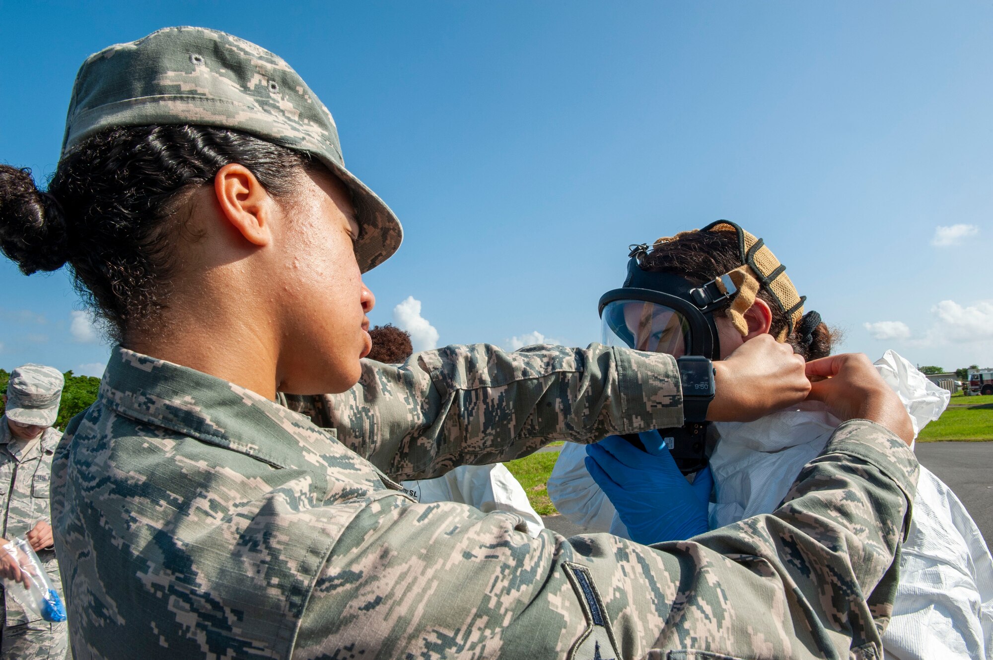 U.S. Air Force Airman Georgia Knight, 18th Aerospace Medicine Squadron bioenvironmental engineering technician, assists an Airman into a level-A suit during a fuel spill exercise at Kadena Air Base, Japan, Oct. 25, 2019. The level-A suit is the highest level protection against vapors, gases, mists and particles, which consists of a fully encapsulating chemical entry suit with a self-contained breathing apparatus. It’s protects Airmen from hazardous material and harmful environments. (U.S. Air Force photo by Naoto Anazawa)