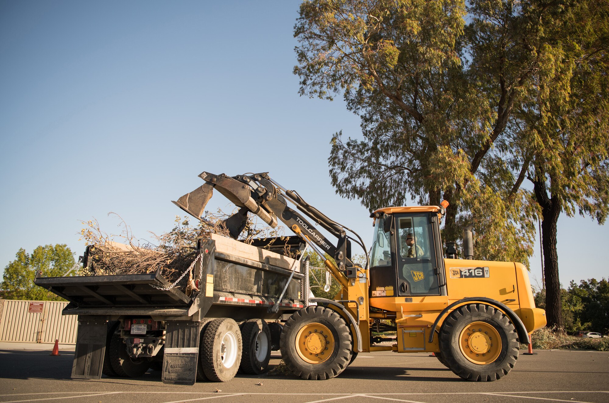 Photos of Travis Airmen cleaning the base of debris.