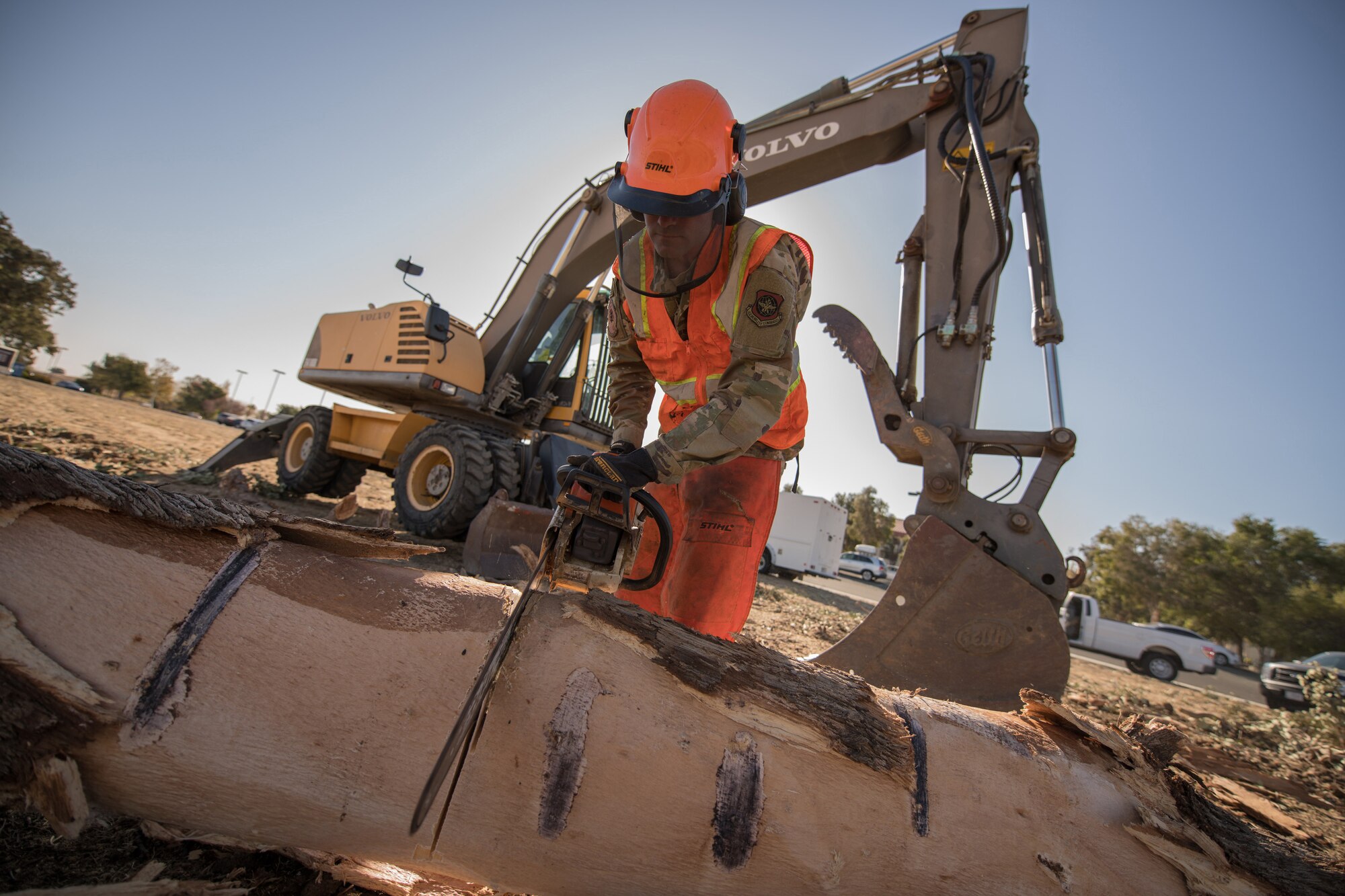 Photos of Travis Airmen cleaning the base of debris.