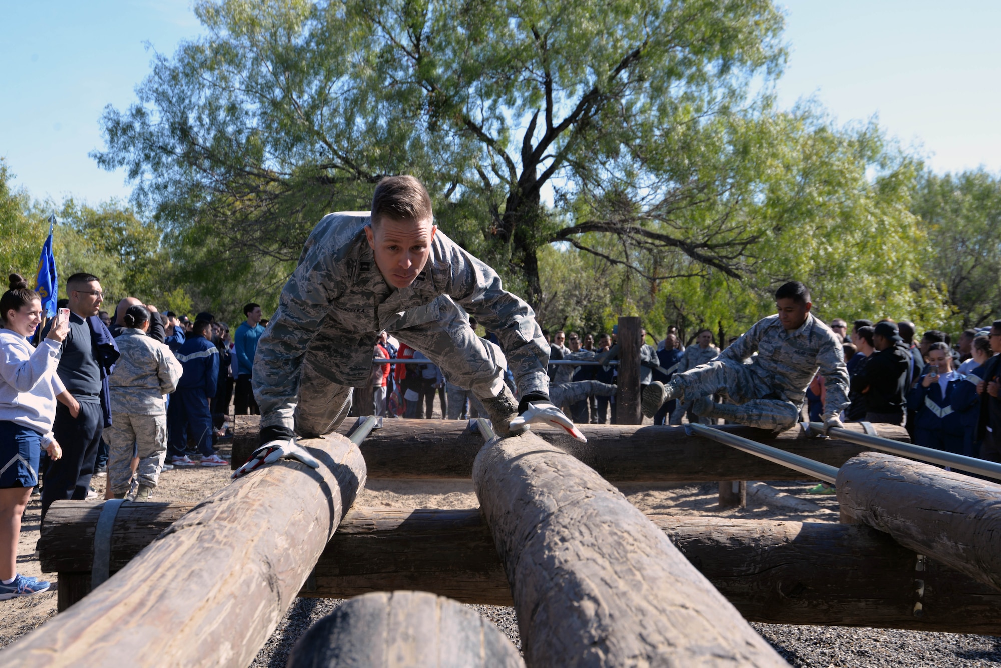 Chaplain (Capt.) Matthew A. Hanzelka, 433rd Airlift Wing chaplain, crawls across an obstacle during a team-building exercise at the 433rd AW Resilience Tactical Pause at the Air Force Basic Military Training’s Basic Expeditionary Airman Skills Training site at the Medina Annex, Joint Base San Antonio-Lackland, Texas Nov. 3, 2019.
