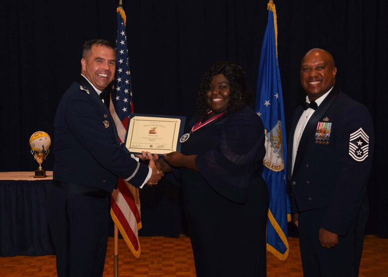 Monica Ashmore, 30th Force Support Squadron lodging assistant manager, receives a certificate during her Airman Leadership School graduation ceremony Oct. 10, 2019, at Vandenberg Air Force Base, Calif. Ashmore is the first civilian to graduate from the Vandenberg Airman Leadership School. The school is a five week course designed to develop Airmen and their civilian counterparts into effective frontline supervisors through group discussion, unit-cohesion activities, physical training and other leadership development curriculum. (U.S. Air Force photo by Airman 1st Class Aubree Milks)
