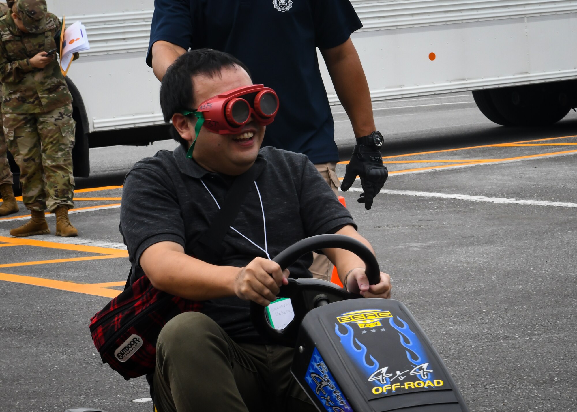 Kazunori Uehara, Twitter Tour visitor, drives a go-cart while wearing drunk goggles during a drunken driving prevention demonstration at Kadena Air Base, Japan, Nov. 4, 2019. Visitors were selected based on when they subscribed to the 18th Wing Twitter page and a brief application process. (U.S. Air Force photo by Staff Sgt. Benjamin Raughton)