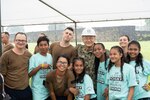 191104-N-WA745-1024 KOLONIA, Pohnpei (Nov. 4, 2019) Seabees deployed with Naval Mobile Construction Battalion (NCMB) 5’s Detail Pohnpei and members of the Sokehs Youth Choir pose for a photograph outside the Kolonia Gymnasium during the Federated States of Micronesia Independence Day celebration in Pohnpei Nov. 4.  The Seabees are providing humanitarian aid to the local community by finishing a medical facility, Nan U Dispensary, and performing renovations to multiple schools across the island. NMCB-5 is deployed across the Indo-Pacific region conducting high-quality construction to support U.S. and partner nations to strengthen partnerships, deter aggression, and enable expeditionary logistics and naval power projection.