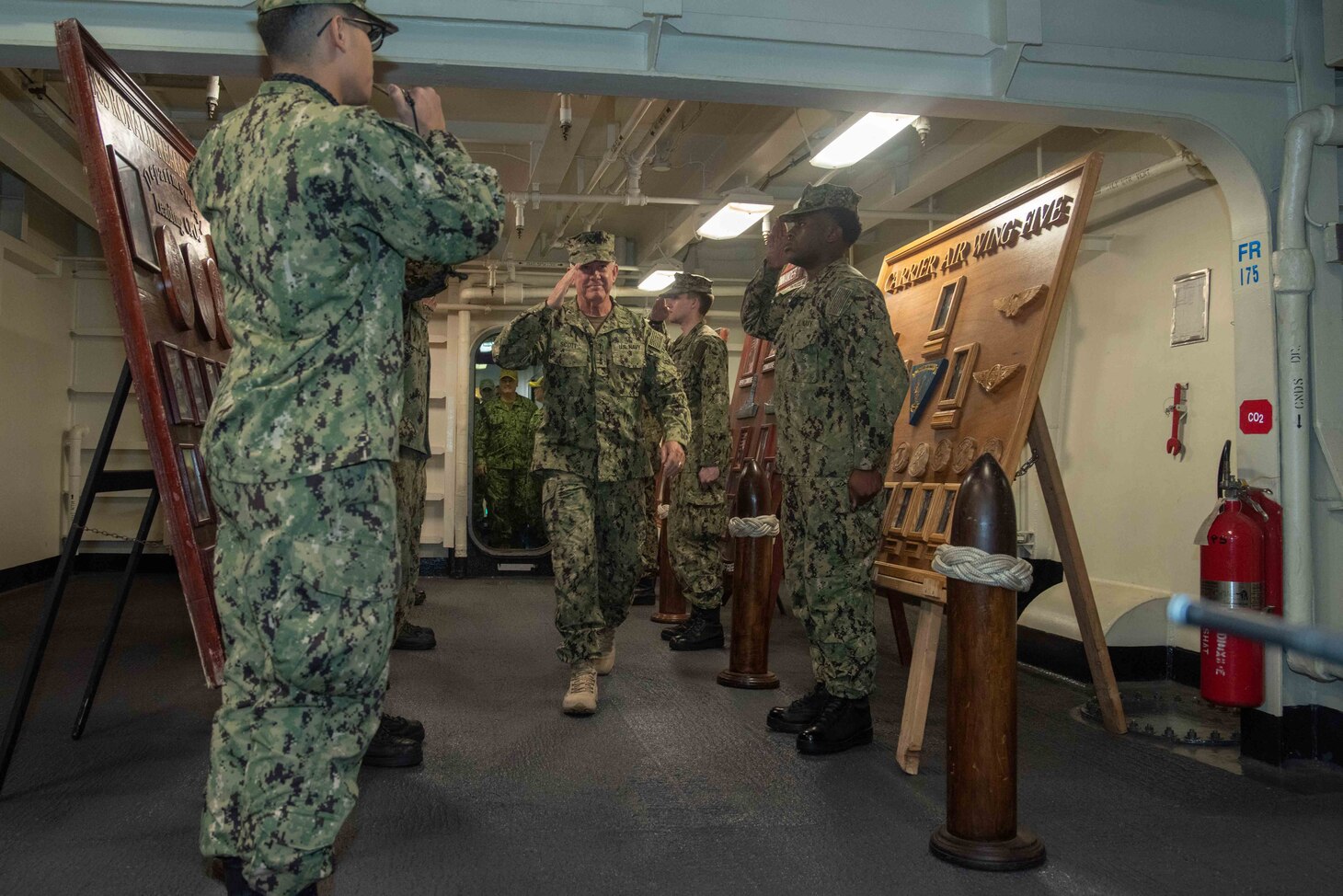 Rear Adm. Brent W. Scott, the U.S. Navy Chief of Chaplains, arrives through the side boys on the Navy’s forward-deployed aircraft carrier, USS Ronald Reagan (CVN 76). Ronald Reagan, the flagship of Carrier Strike Group 5, provides a combat-ready force that protects and defends the collective maritime interests of its allies and partners in the Indo-Pacific region. (U.S. Navy photo by Mass Communication Specialist )