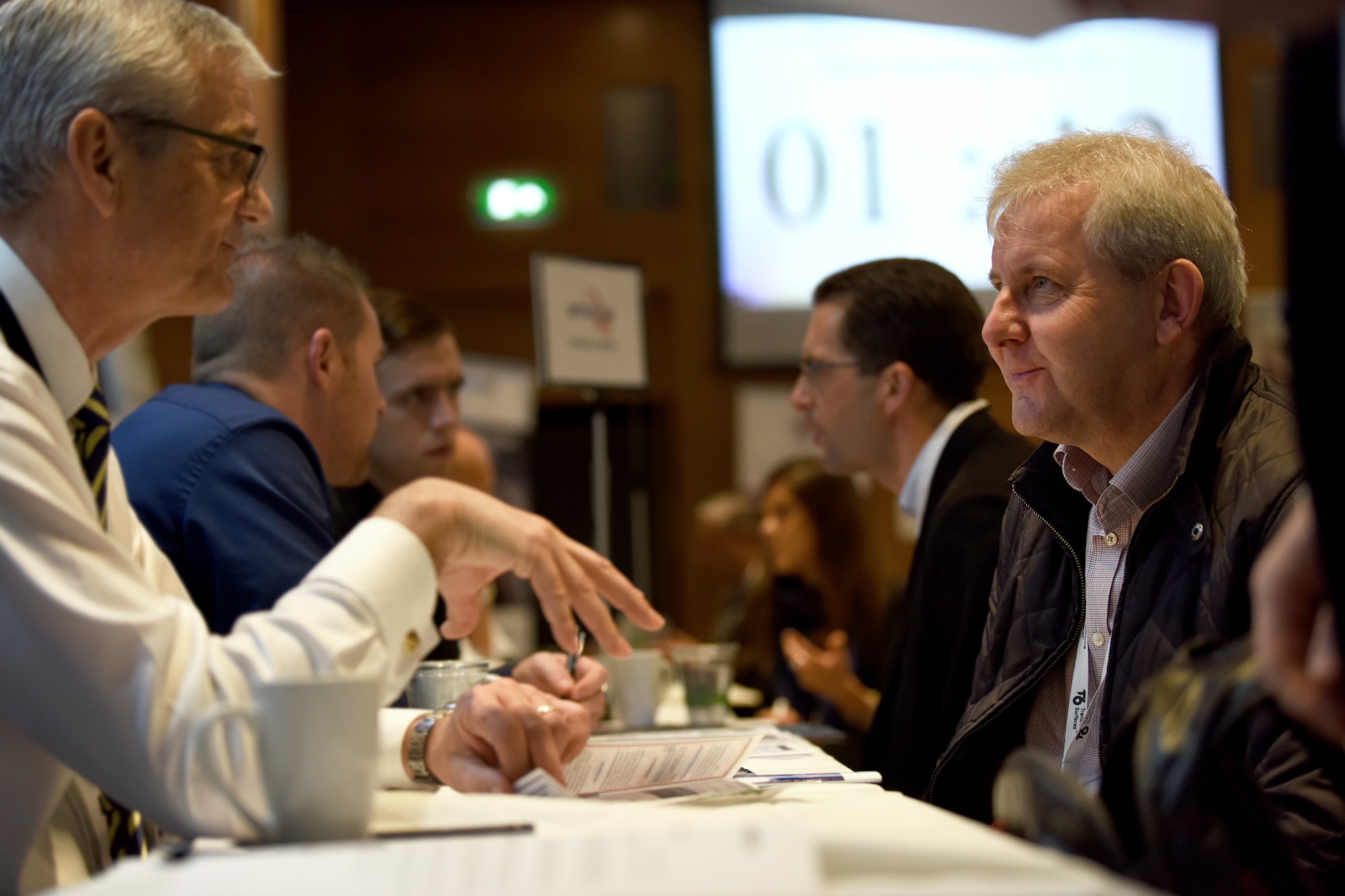 Paul Mayes, 48th Contracting Squadron flight chief, talks with an attendee at the London Stansted Airport Meet the Buyers event in Stansted, England, Nov. 5, 2019. This is a distinctive occasion for both the Liberty Wing and civilian contractors to get the chance to talk about potential business partnerships and ideas. (U.S. Air Force photo by Airman 1st Class Madeline Herzog)