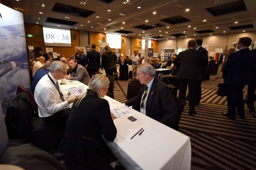 Attendees at the London Stansted Airport Meet the Buyers event discuss potential business opportunities in Stansted, England, Nov. 5, 2019. This is a distinctive occasion for both the Liberty Wing and civilian contractors to get the chance to talk about potential business partnerships and ideas. (U.S. Air Force photo by Airman 1st Class Madeline Herzog)