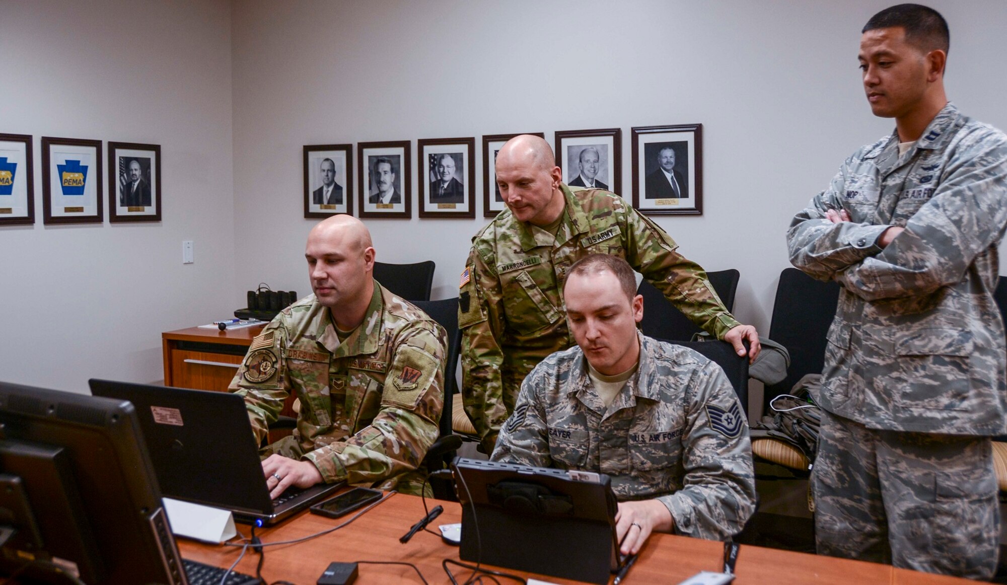 Approximately 30 members of the Pennsylvania National Guard joined other state agencies at three locations Nov. 5 to ensure the security of the commonwealth’s general election. A team at the Pennsylvania Emergency Management Agency (above) focused on network monitoring, while teams at Fort Indiantown Gap and Horsham Air Guard Station focused on social media reporting. (U.S. Army National Guard photo by Staff Sgt. Zane Craig)