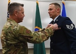 Brig. General Jeremy Horn, Washington Air National Guard commander, pins the Washington State Guardsman Medal on Staff Sgt. Jonathan Tinsley, 116th Air Support Operations Squadron Tactical Air Control Party, Nov. 2, 2019, at Camp Murray, Washington. Tinsley received the medal for stopping an attacker from assaulting two people.