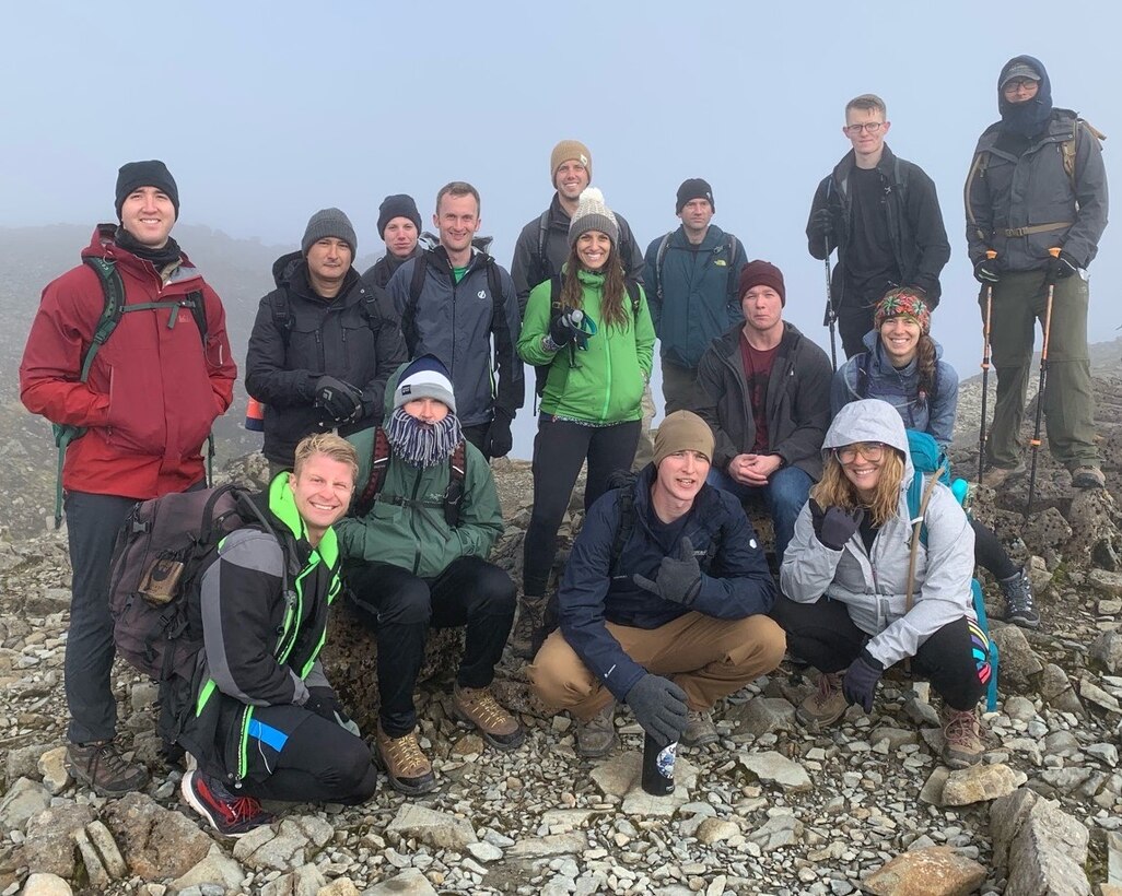 After four hours up the rocky incline, crystal cold mist floated just above the rocky terrain at the top with gaps giving way to intense sunlight and views across the Scottish Highlands. Selfies and staged photos were plentiful to record the triumph. The march down acquainted them with light fatigue, hunger for a warm meal, and a vague idea of the exertion expected ahead