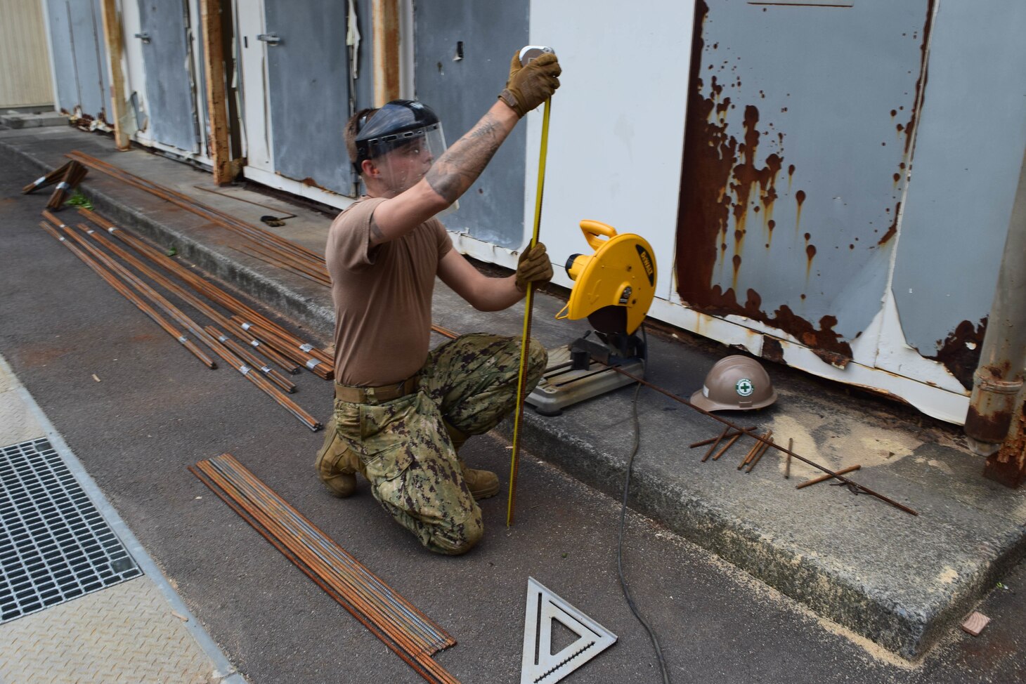 191025-N-EO124-0024 IWAKUNI, Japan (Oct. 25, 2019) Steelworker Constructionman Garrett Wells, from Yale, Michigan, deployed with Naval Mobile Construction Battalion (NMCB) 5’s Detail Iwakuni, prefabricates reinforced steel for an environmental trash enclosure project.  NMCB-5 is deployed across the Indo-Pacific region conducting high-quality construction to support U.S. and partner nations to strengthen partnerships, deter aggression, and enable expeditionary logistics and naval power projection.