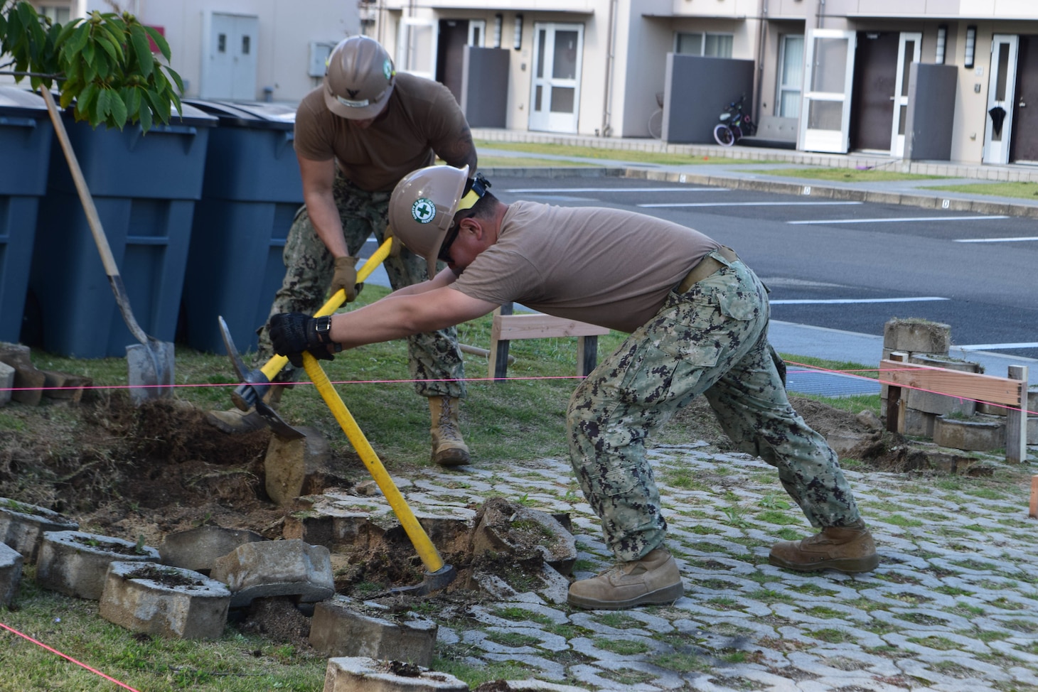 191028-N-EO124-0089 IWAKUNI, Japan (Oct. 28, 2019) Equipment Operator 3rd Class David Francis, from Jefferson City, Missouri, and Equipment Operator 3rd Class Zhen Liu, from Oxnard, California, both deployed with Naval Mobile Construction Battalion (NMCB) 5’s Detail Iwakuni, pull pavers with pickaxes to clear for excavation. NMCB-5 is deployed across the Indo-Pacific region conducting high-quality construction to support U.S. and partner stations to strengthen partnerships, deter aggression, and enable expeditionary logistics and naval power projection.