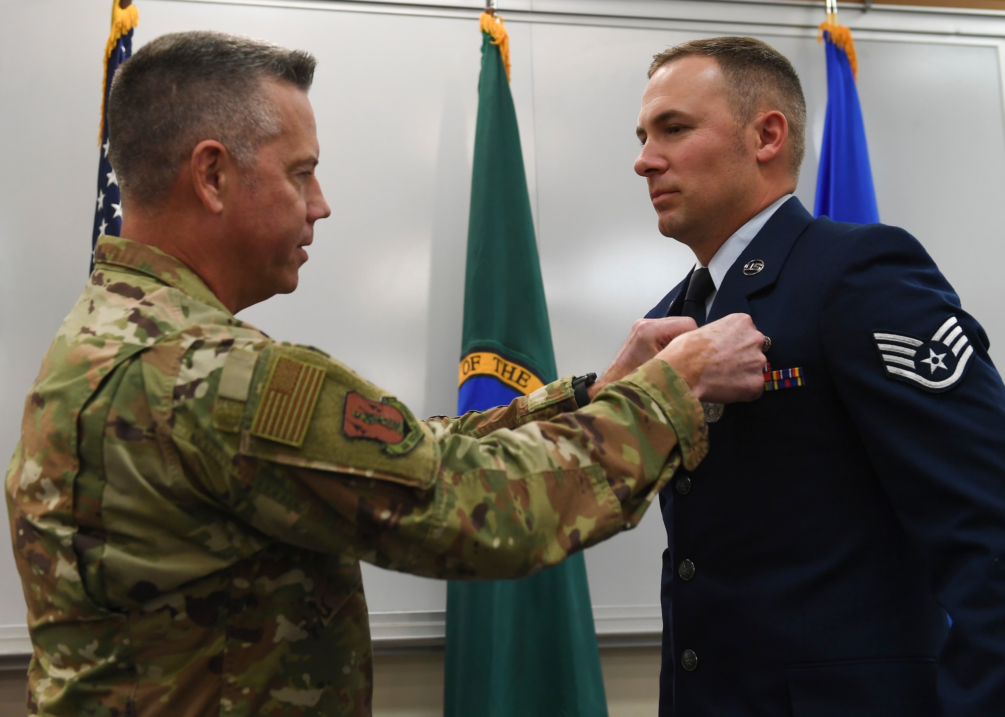 Brig. General Jeremy Horn, Washington Air National Guard commander, pins the Washington State Guardsman Medal on Staff Sgt. Jonathan Tinsley, 116th Air Support Operations Squadron Tactical Air Control Party, Nov. 2, 2019, at Camp Murray, Washington. Tinsley received the medal for stopping an attacker from assaulting two people.