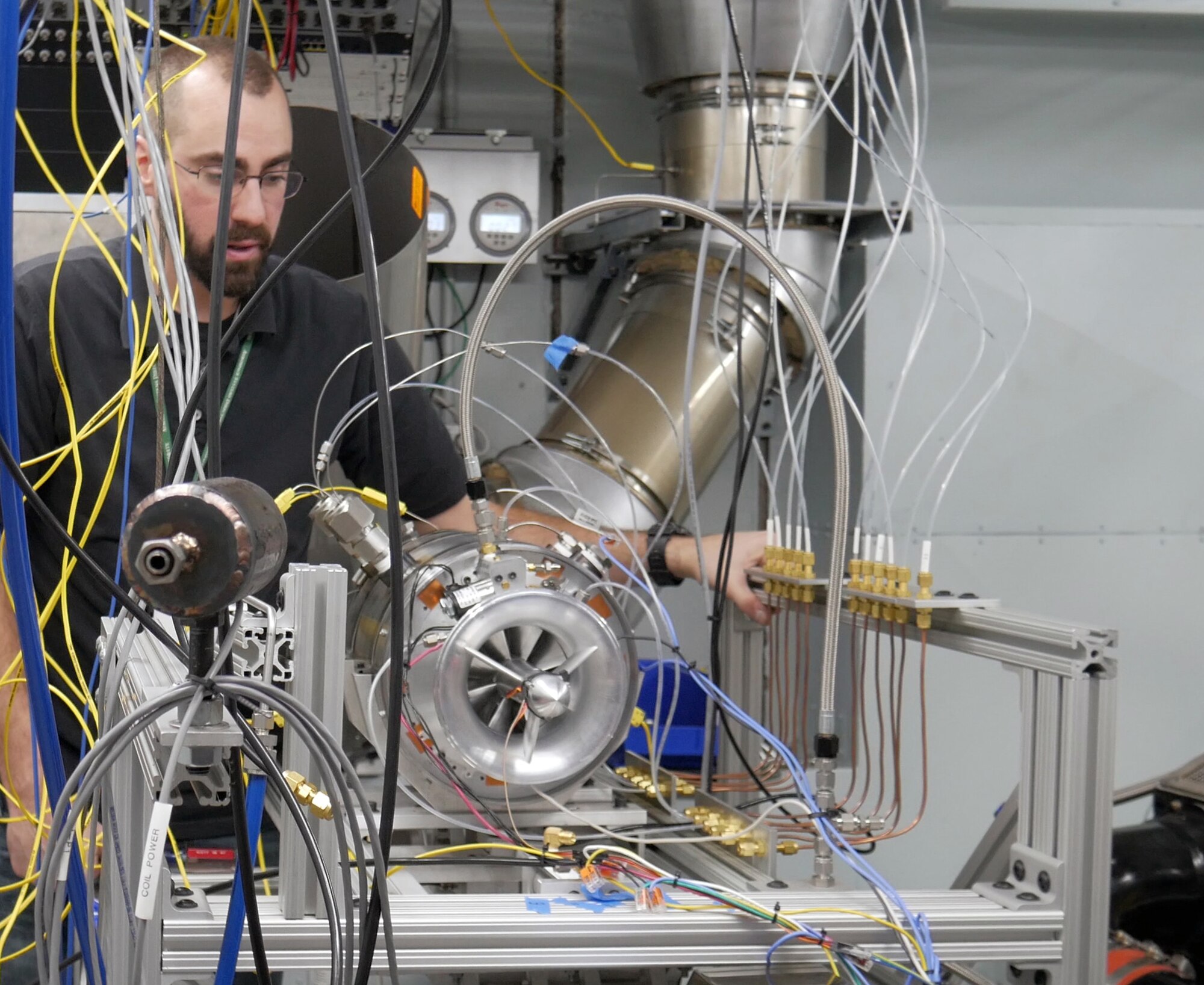 Air Force Research Laboratory engineer Justin Reinhart makes final adjustments on the Responsive Open Source Engine on the test stand. ROSE is a rapid development effort executed within 13 months and is the first turbine engine designed, assembled, and tested exclusively within AFRL. (U.S. Air Force Photo/David Dixon)