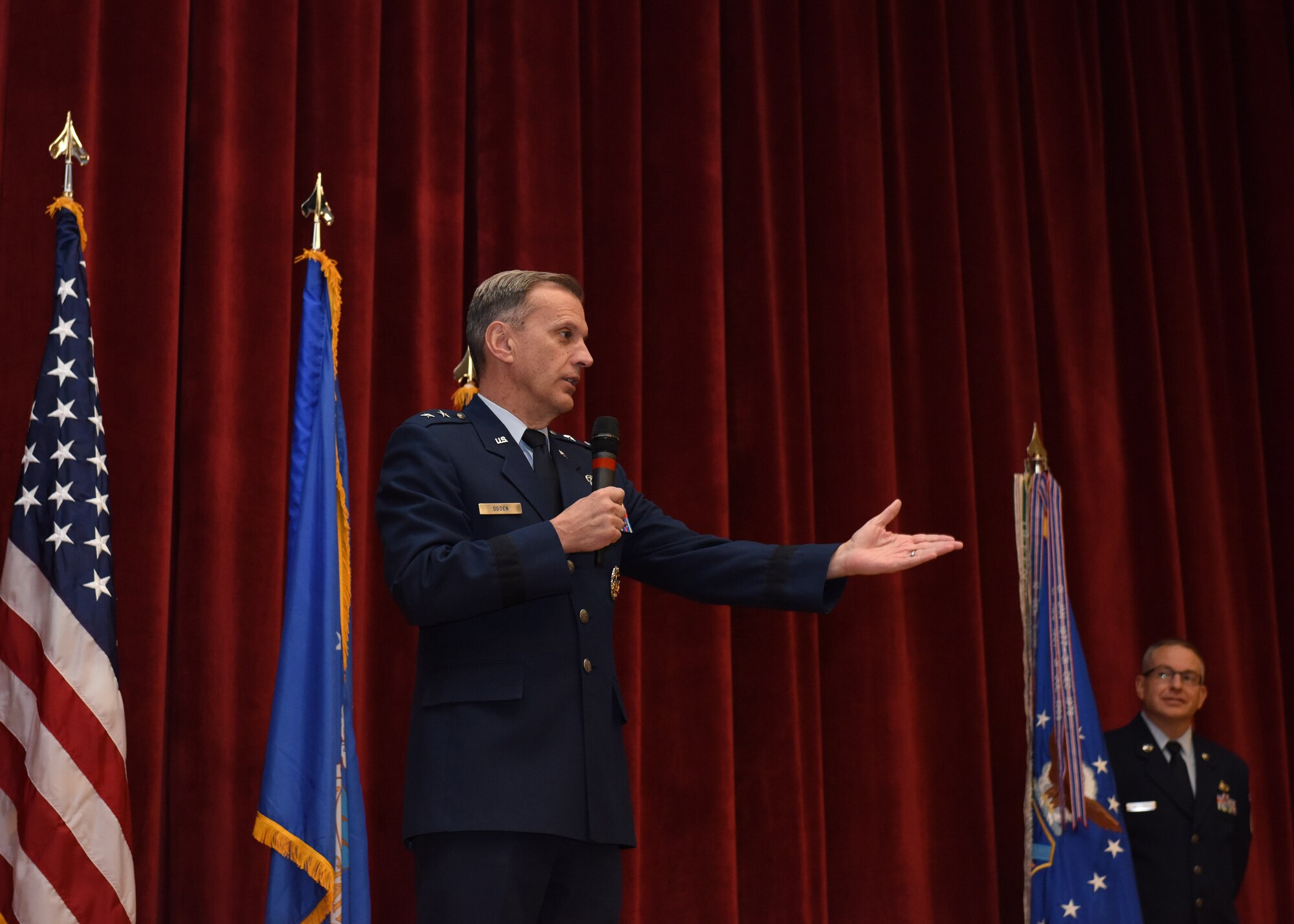 Maj. Gen. Randall A. Ogden, 4th Air Force commander, introduces Col. John F. Robinson as the new commander of the 911th Airlift Wing during a ceremony at Moon Area Middle School in Coraopolis, Pennsylvania, Nov. 2, 2019.