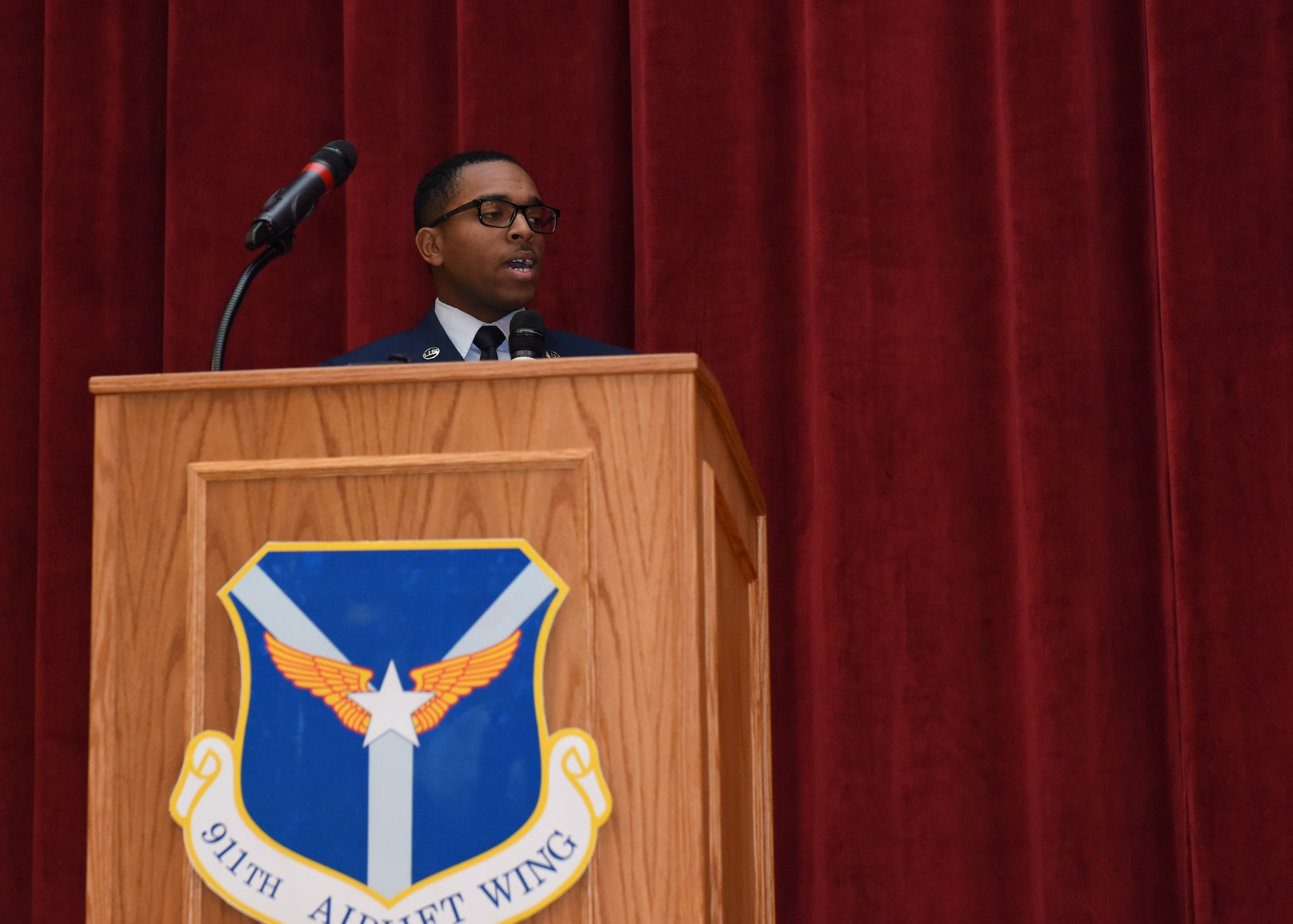 Senior Airman Joseph Dukes, knowledge operations management specialist with the 911th Communications Squadron, sings the National Anthem at an assumption of command ceremony in honor of 911th Airlift Wing commander Col. John F. Robinson at Moon Area Middle School in Coraopolis, Pennsylvania, Nov. 2, 2019.