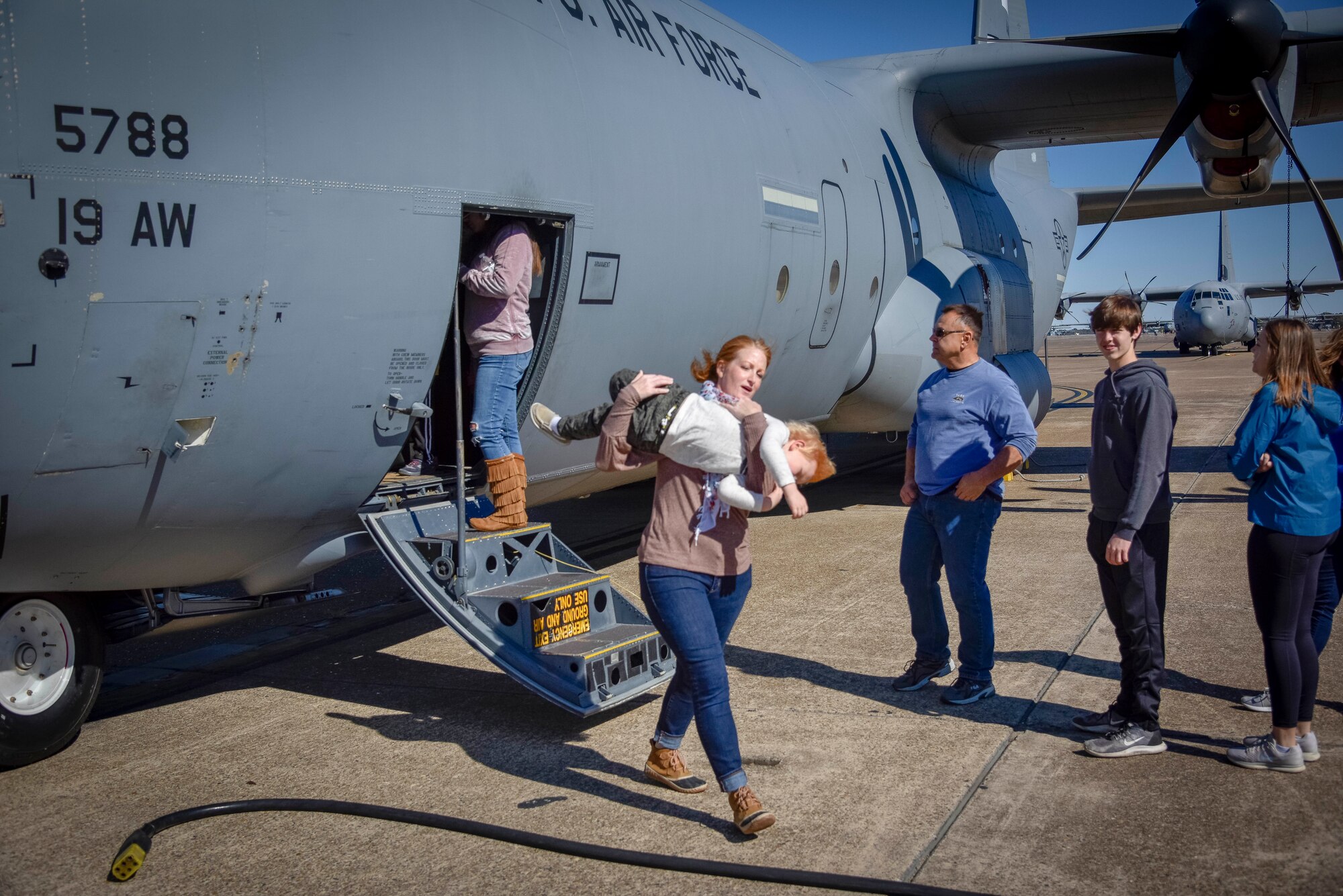 Family members walk through and tour a static display of a C-130J Hercules aircraft on Nov. 2, 2019, at Little Rock Air Force Base, Ark. The 913th Airlift Group hosted a family day event, celebrating and showing appreciation for family members' support of their Airmen. (U.S. Air Force Reserve photo by Senior Airman Nathan Byrnes)