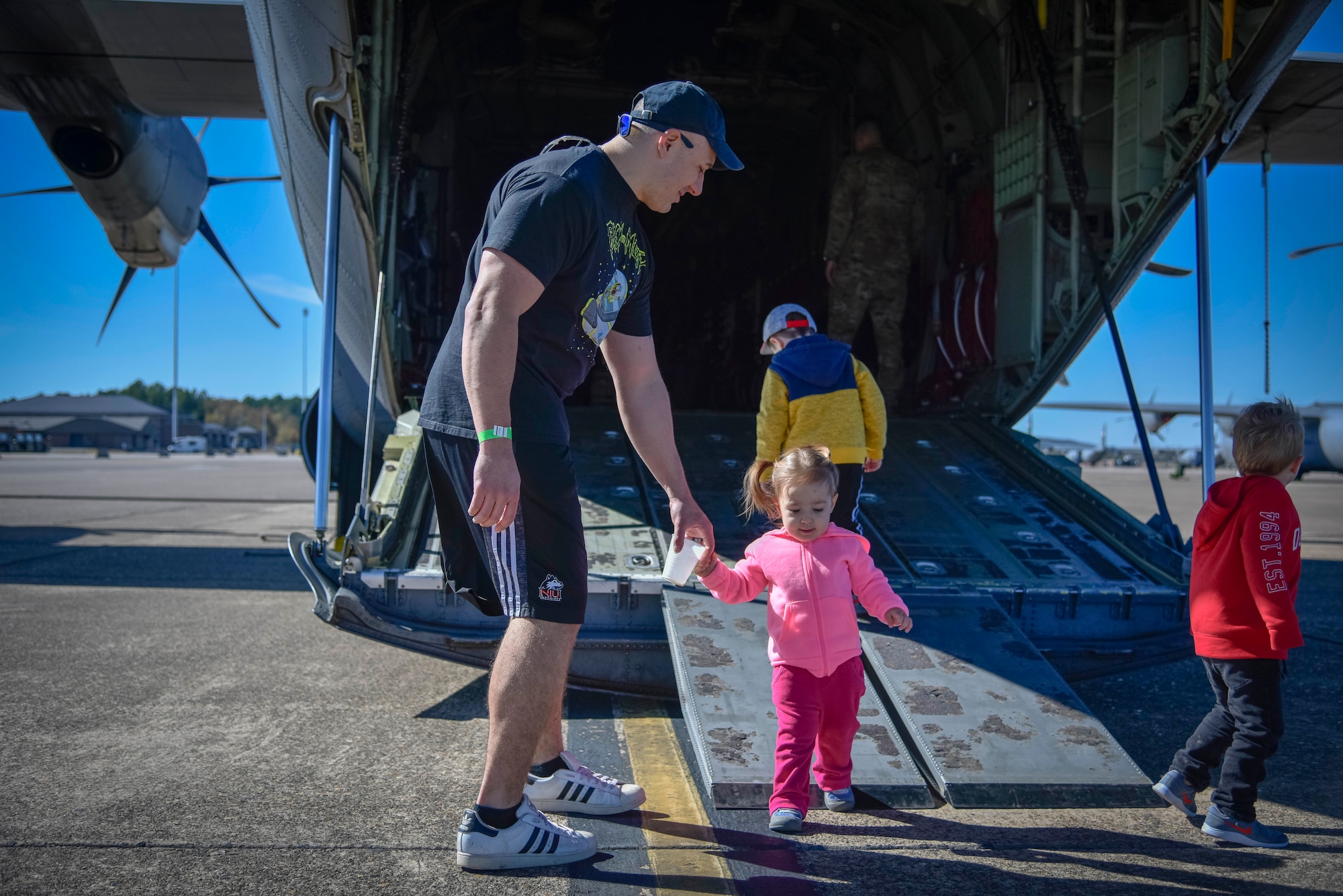 Family members walk through and tour a static display of a C-130J Hercules aircraft on Nov. 2, 2019, at Little Rock Air Force Base, Ark. The 913th Airlift Group hosted a family day event, celebrating and showing appreciation for family members' support of their Airmen. (U.S. Air Force Reserve photo by Senior Airman Nathan Byrnes)