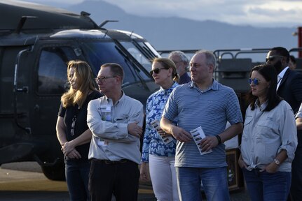 Members of the US House of Representatives stand in front of a UH-60 Blackhawk on Soto Cano Air Base.