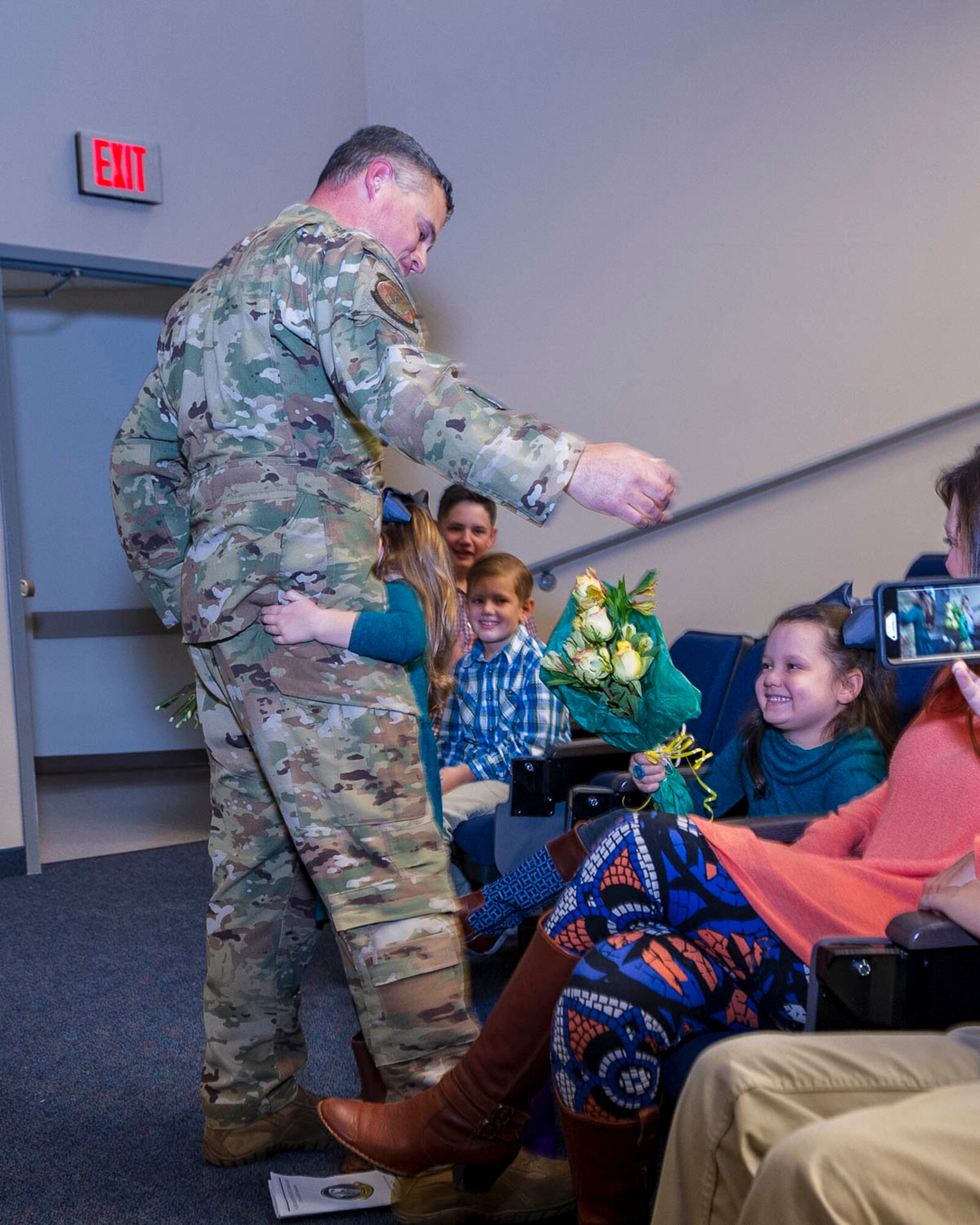 Lt. Col. Jeremy Wagner, 327th Airlift Squadron commander, presents flowers to his family during an assumption of command ceremony on Nov. 2, 2019, at Little Rock Air Force Base, Ark. Previous to his current assignment, Lt. Col. Wagner was the chief pilot for the unit. (U.S. Air Force Reserve photo by Maj. Ashley Walker)