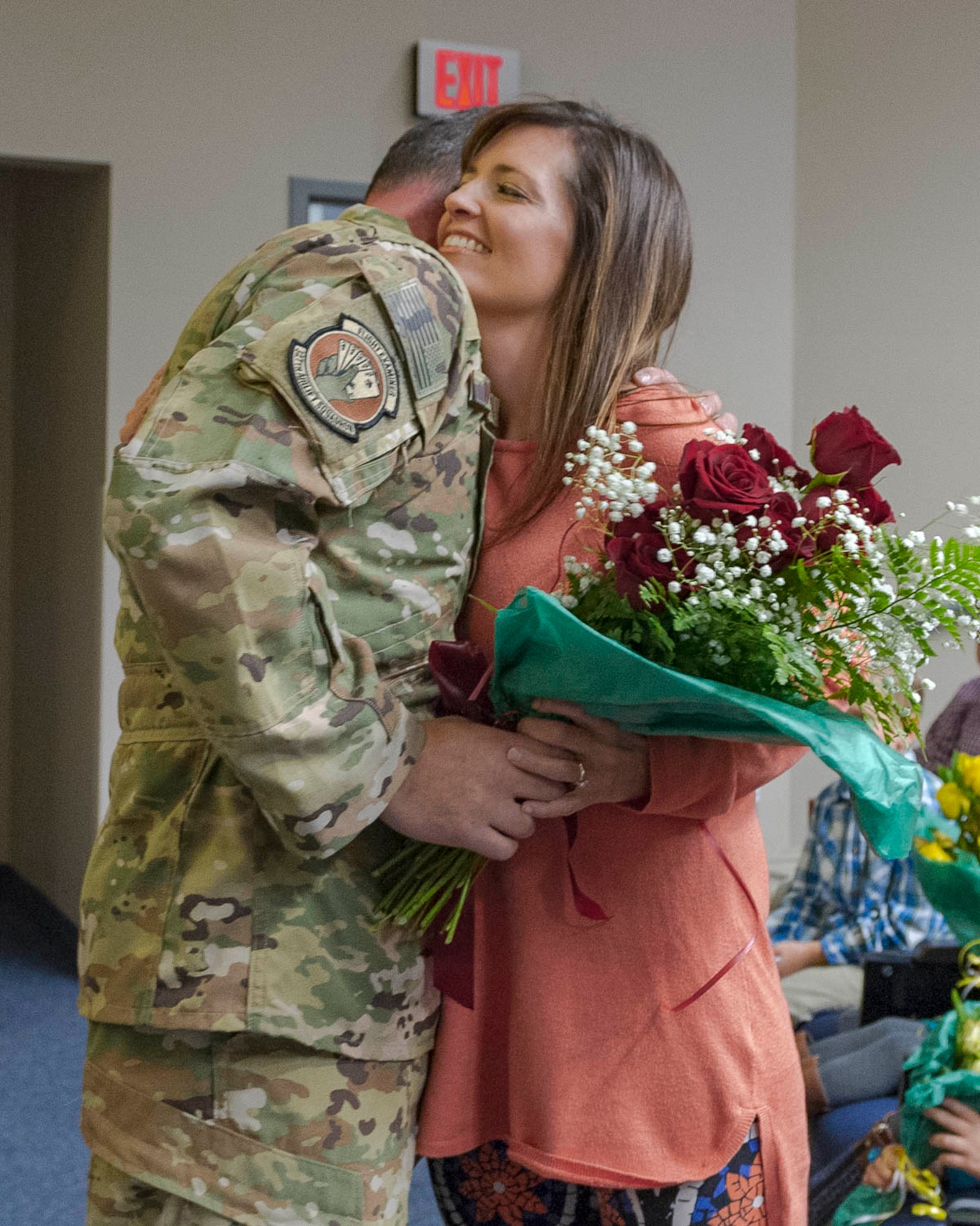 Lt. Col. Jeremy Wagner, 327th Airlift Squadron commander, presents flowers to his spouse during an assumption of command ceremony on Nov. 2, 2019, at Little Rock Air Force Base, Ark. Previous to his current assignment, Lt. Col. Wagner was the chief pilot for the unit. (U.S. Air Force Reserve photo by Maj. Ashley Walker)
