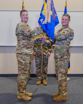 913th Airlift Group deputy commander Col. Daniel Collister (left) passes the guidon to 327th Airlift Squadron commander Lt. Col. Jeremy Wagner during the assumption of command ceremony at Little Rock Air Force Base, Ark. Nov. 3, 2019. Previous to his command, Lt. Col. Wagner was the chief pilot for the squadron who has more than 2,800 hours in the C-130. (U.S. Air Force Reserve photo by Maj. Ashley Walker)