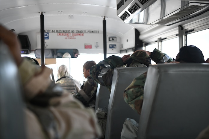 Airmen don Mission Oriented Protective Posture gear while on a bus headed for lunch after a simulated chemical attack is announced during Palmetto Challenge at McEntire Joint National Guard Base, S.C., Nov. 4, 2019. The goal of the exercise was to develop and maintain full-spectrum readiness and ensure JB Charleston’s Airmen were ready for rapid mobilization and able to support Air Mobility Command and DOD priorities. Both active-duty and reserve Airmen from the 628th Air Base Wing, 437th Airlift Wing and 315th Airlift Wing came together to train in operating in an austere environment. More than 140 Airmen took part in the global mobilization readiness exercise at McEntire Joint National Guard Base, and Pope Army Airfield, S.C.