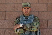 Portrait of an Airman standing in front of a brick wall