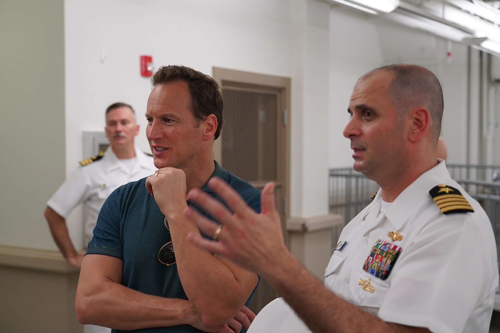 U.S. PACFLT Director of Intelligence and Information Operations Capt. Tony Butera, considered the current equivalent of World War II intelligence officer Edwin Layton, walks actor Patrick Wilson through Station Hypo during a special tour of the now-declassified space.