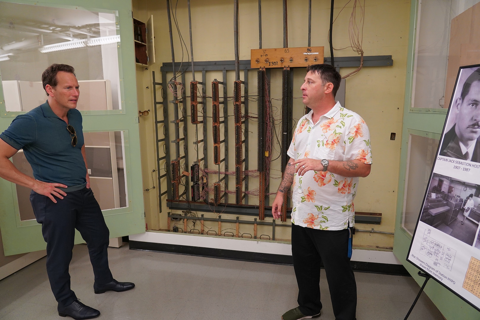 PHNSY&IMF Engineering Technician Noah Green gives actor Patrick Wilson an overview of the fiddle board once used to intercept encrypted Japanese intelligence at Station Hypo.