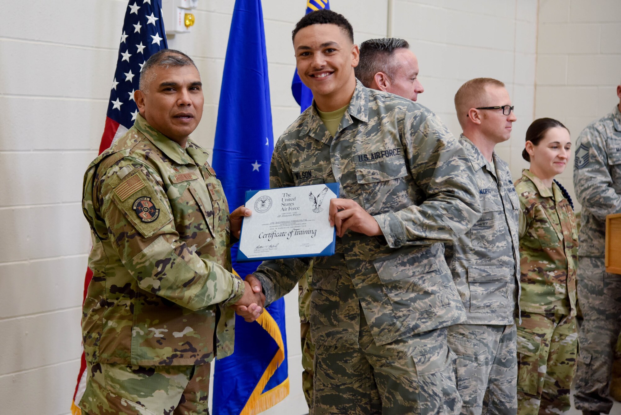 Col. Anthony Puente, 982nd Training Group commander, presents Airman Ahstawn Wilson, 22nd Maintenance Squadron crew chief, with a Certificate of Training during the Mission Ready Airmen program graduation Nov. 5, 2019, at McConnell Air Force Base, Kan. The MRA program took 56 academic days to complete. (U.S. Air Force photo by Airman 1st Class Marc A. Garcia)