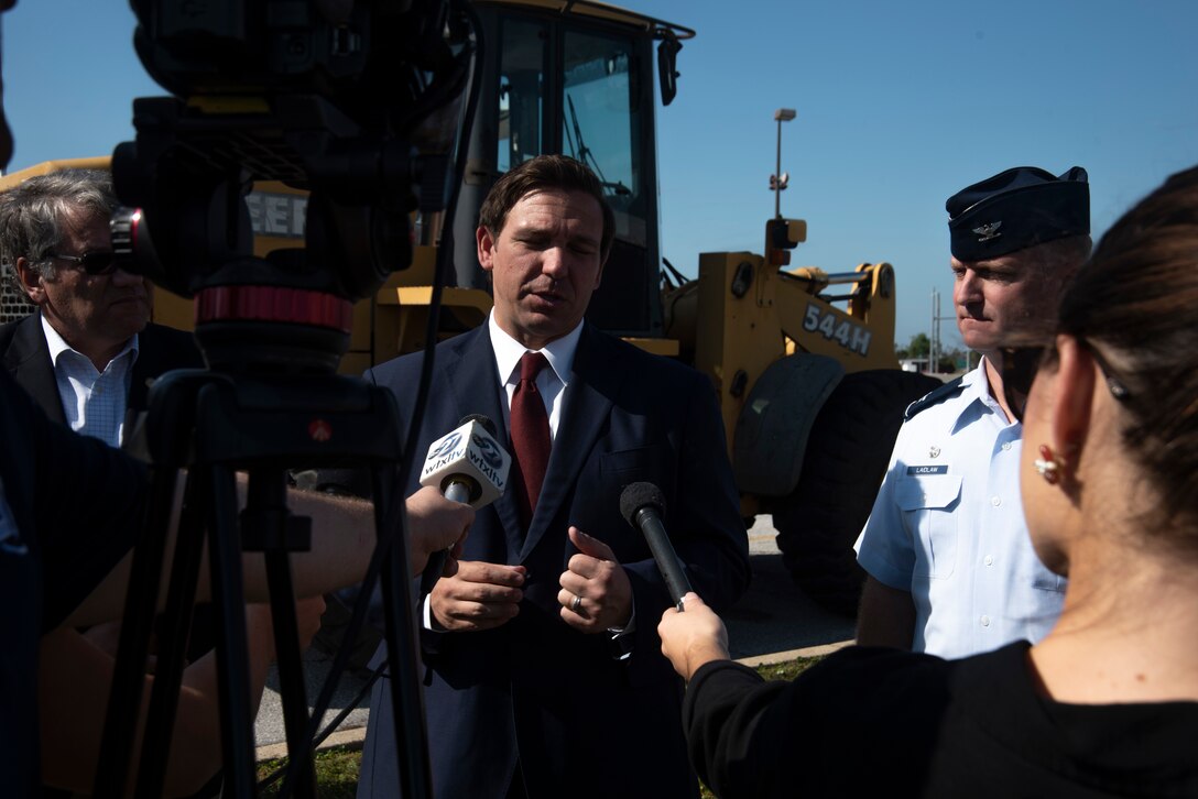 Ron DeSantis, Governor of Florida, left, and Brian Laidlaw, 325th Fighter Wing commander, right, are interviewed at a press pool during a groundbreaking ceremony Nov. 6, 2019, at Tyndall Air Force Base, Florida. A groundbreaking ceremony for the U.S. 98/Tyndall Air Force Base Flyover was held at Tyndall’s Flag Park. The flyover will improve mobility by separating through traffic on U.S. 98 from drivers entering and exiting Tyndall. The project represents a continued partnership with the State of Florida in supporting the rebuild process of Tyndall. This was a collaborative effort of the Florida Department of Transportation, the Federal Highway Administration, and Tyndall’s 325th Fighter Wing. (U.S. Air Force photo by Staff Sgt. Magen M. Reeves)