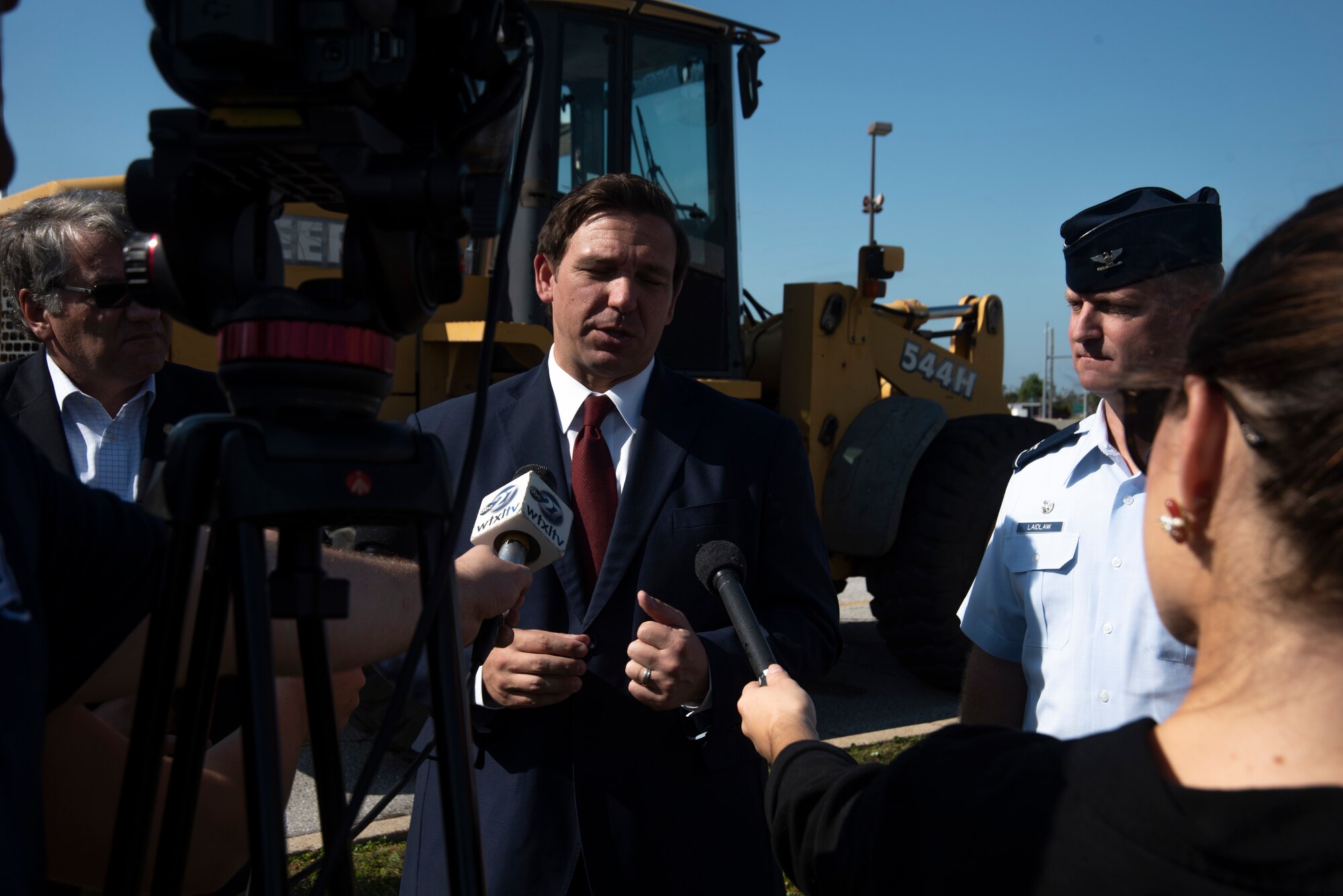 Ron DeSantis, Governor of Florida, left, and Brian Laidlaw, 325th Fighter Wing commander, right, are interviewed at a press pool during a groundbreaking ceremony Nov. 6, 2019, at Tyndall Air Force Base, Florida. A groundbreaking ceremony for the U.S. 98/Tyndall Air Force Base Flyover was held at Tyndall’s Flag Park. The flyover will improve mobility by separating through traffic on U.S. 98 from drivers entering and exiting Tyndall. The project represents a continued partnership with the State of Florida in supporting the rebuild process of Tyndall. This was a collaborative effort of the Florida Department of Transportation, the Federal Highway Administration, and Tyndall’s 325th Fighter Wing. (U.S. Air Force photo by Staff Sgt. Magen M. Reeves)