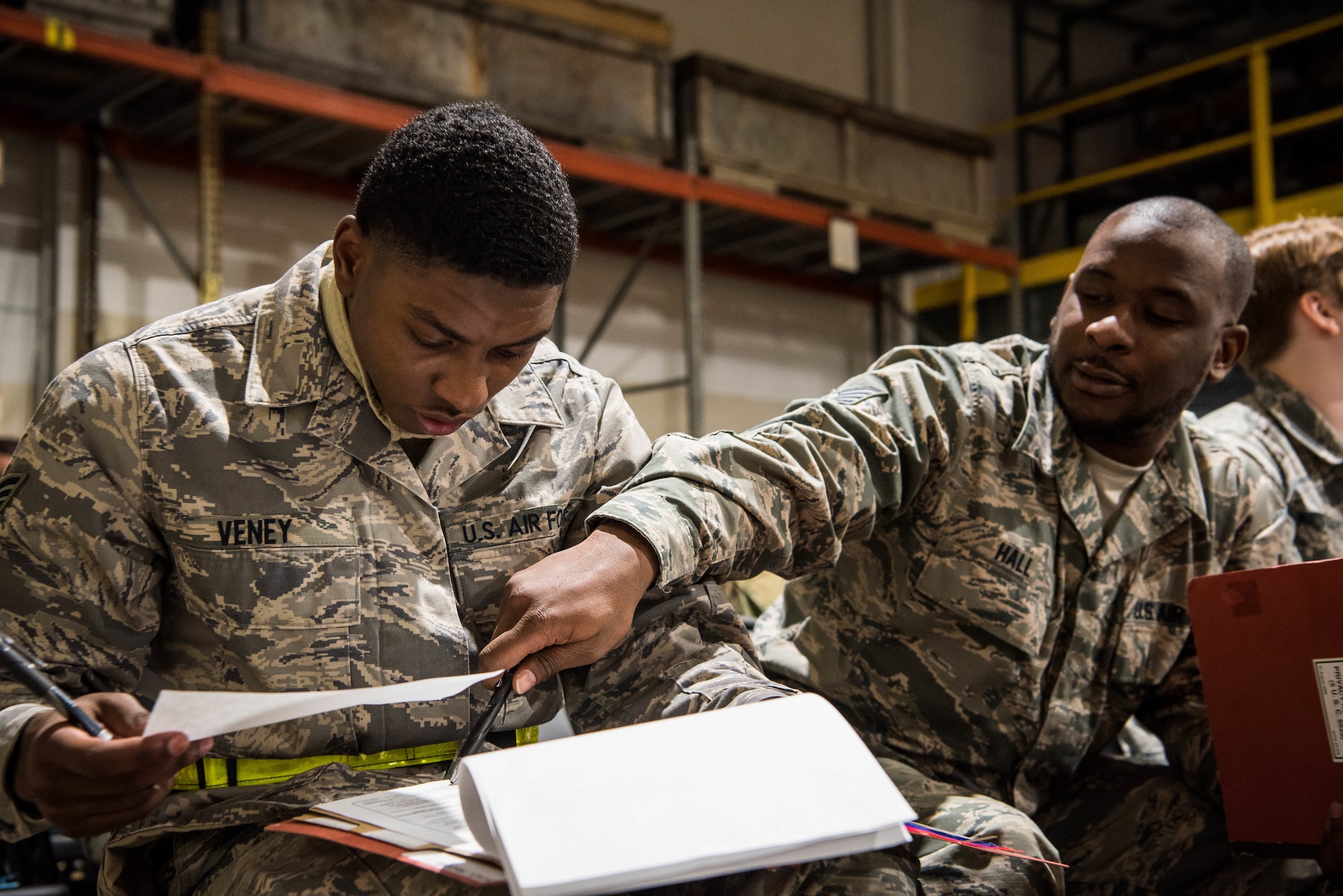 Airmen fill out paperwork