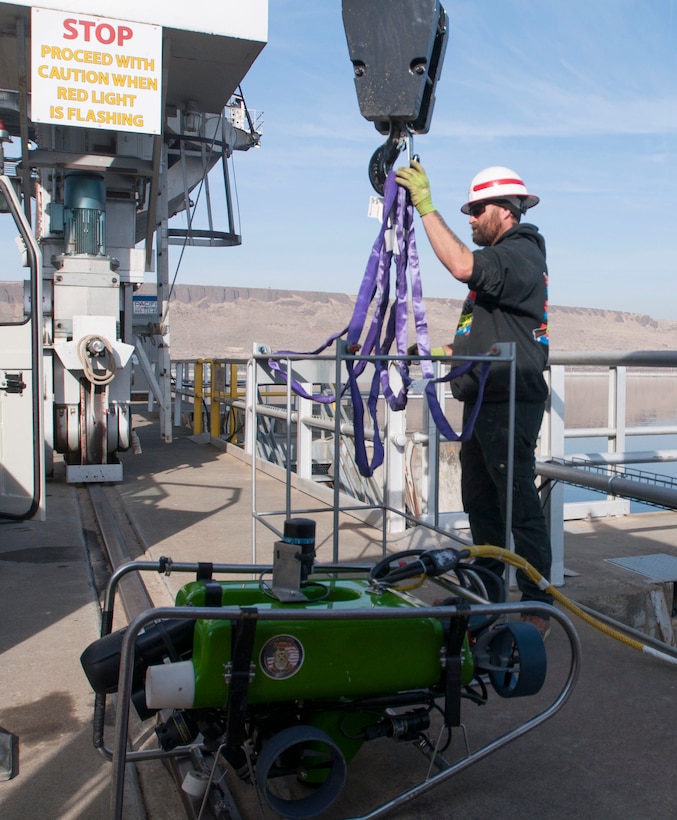 Joel Raplee of McNary's rigging crew hooking up the ROV's basket to the crane.