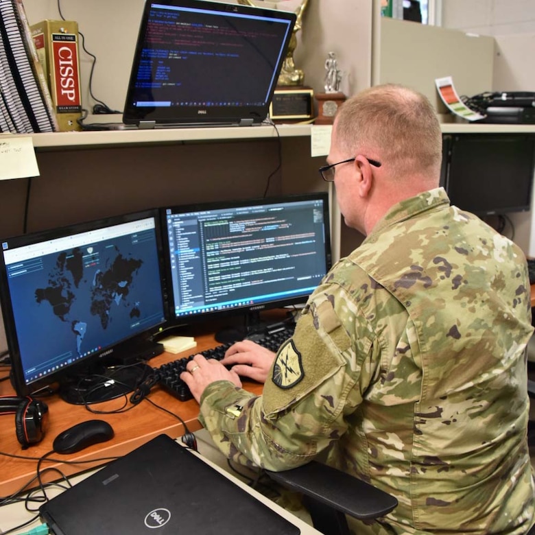 Soldier reviews cyber coding software.