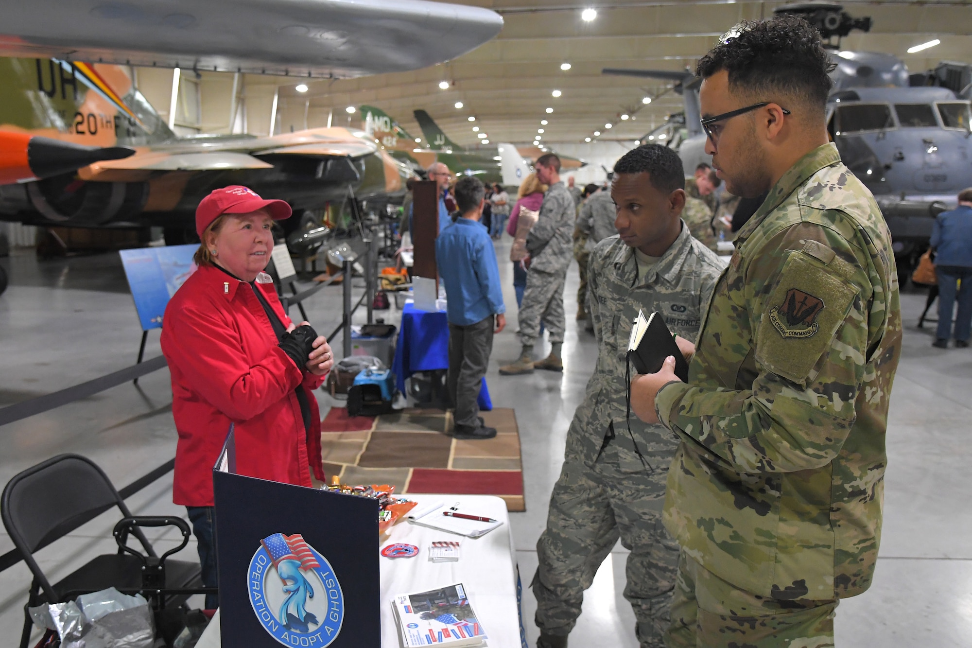 (Left to right) Linda Larson, representing Operation Adopt a Ghost, a charity support Utah soldiers, talks with Airman 1st Class Feruzi Mdee and Airman 1st Class Waldemar Brodhurst, both 729th Air Control Squadron, during the 2019 Combined Federal Campaign Kickoff and Exposition event held at the Hill Aerospace Museum Nov. 4, 2019, at Hill Air Force Base, Utah. The CFC is schedule to run Nov. 4 through Dec. 15 at Hill AFB. (U.S. Air Force photo by Todd Cromar)